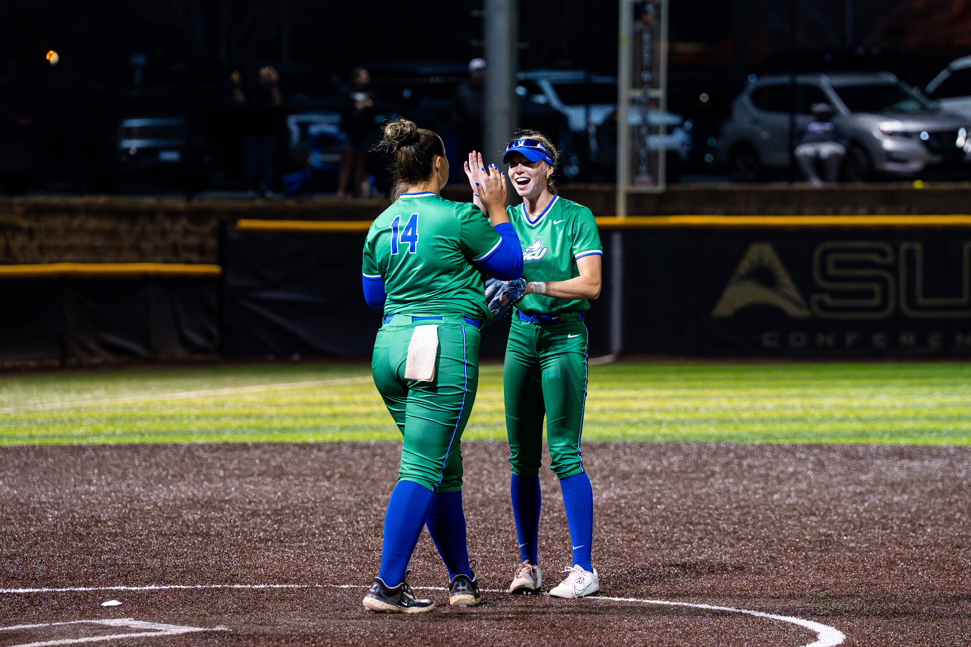 Nikki Gibson high fives Grace Taylor // Credit Queens Athletics