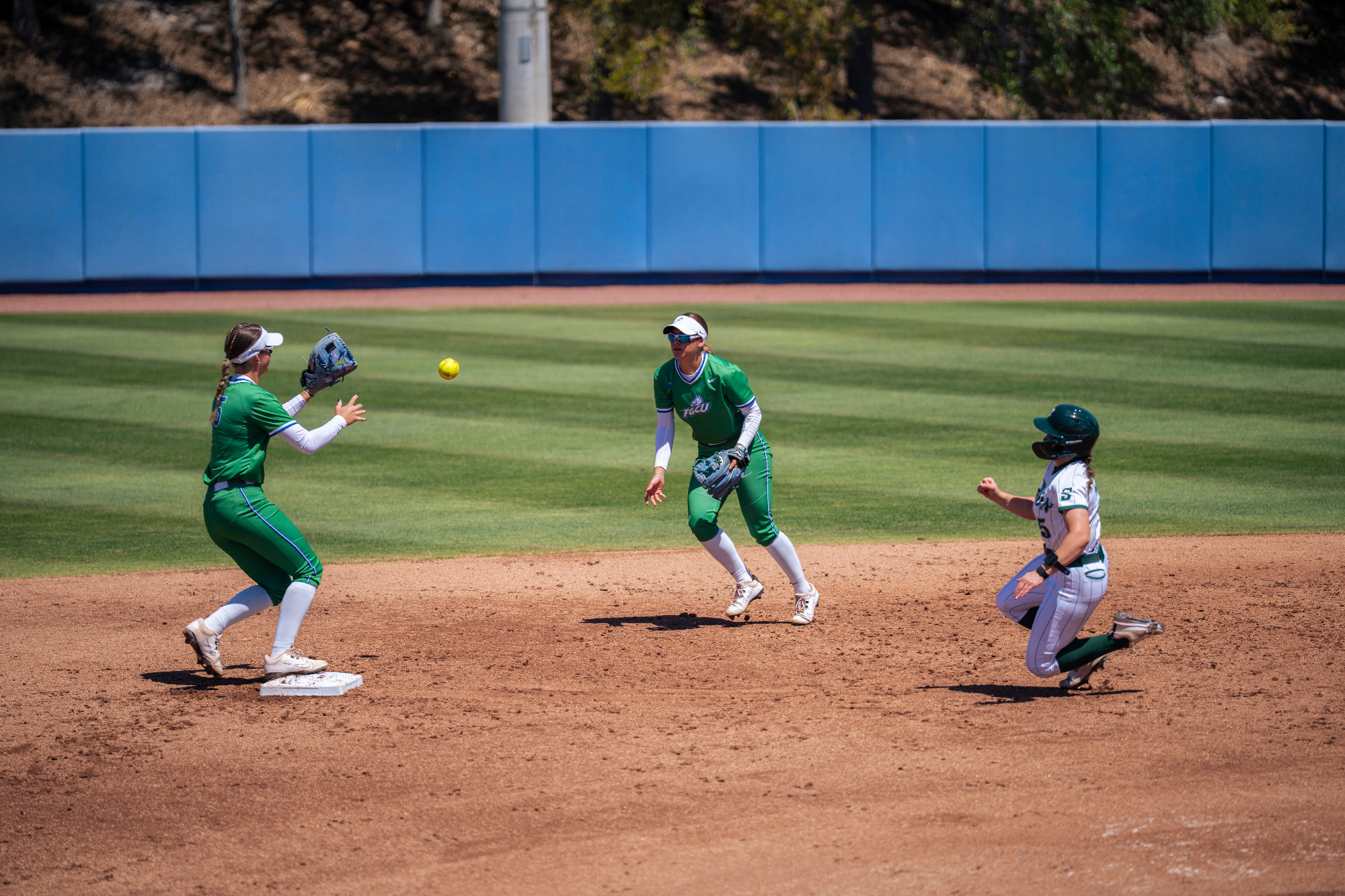 Ally Thompson flips the ball to Sophie Wylie for an out at second base