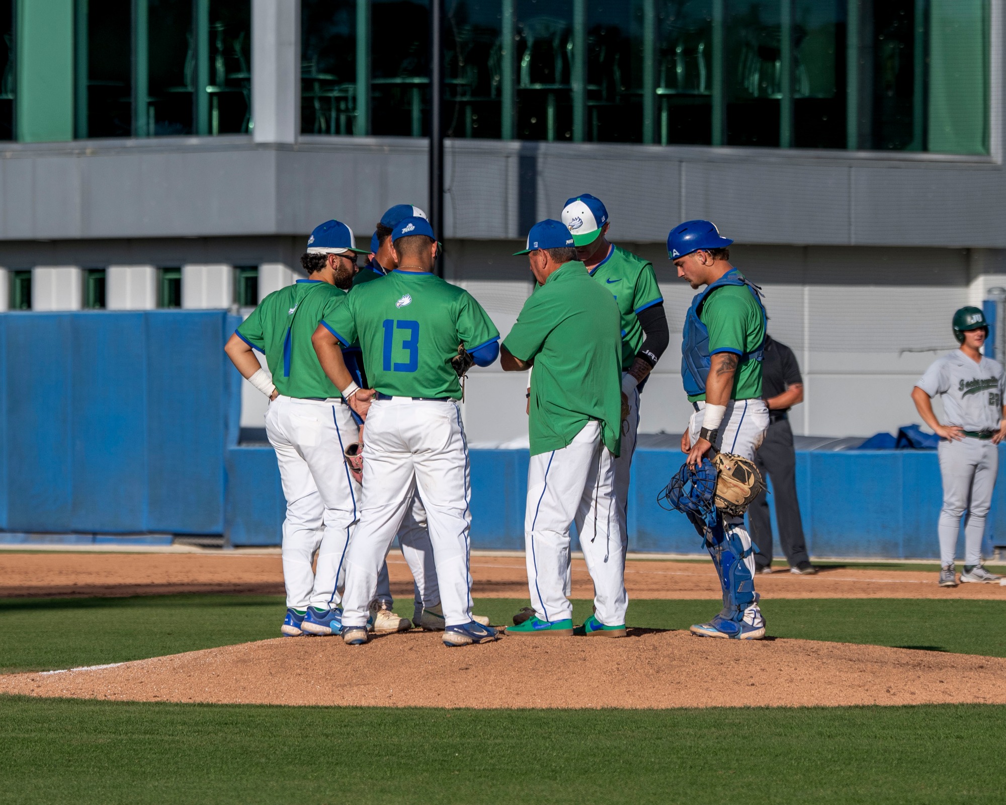 A mid-game mound huddle as FGCU hosts Jacksonville in the second of a three-game Atlantic Sun Conference series at Swanson Stadium in Fort Myers.