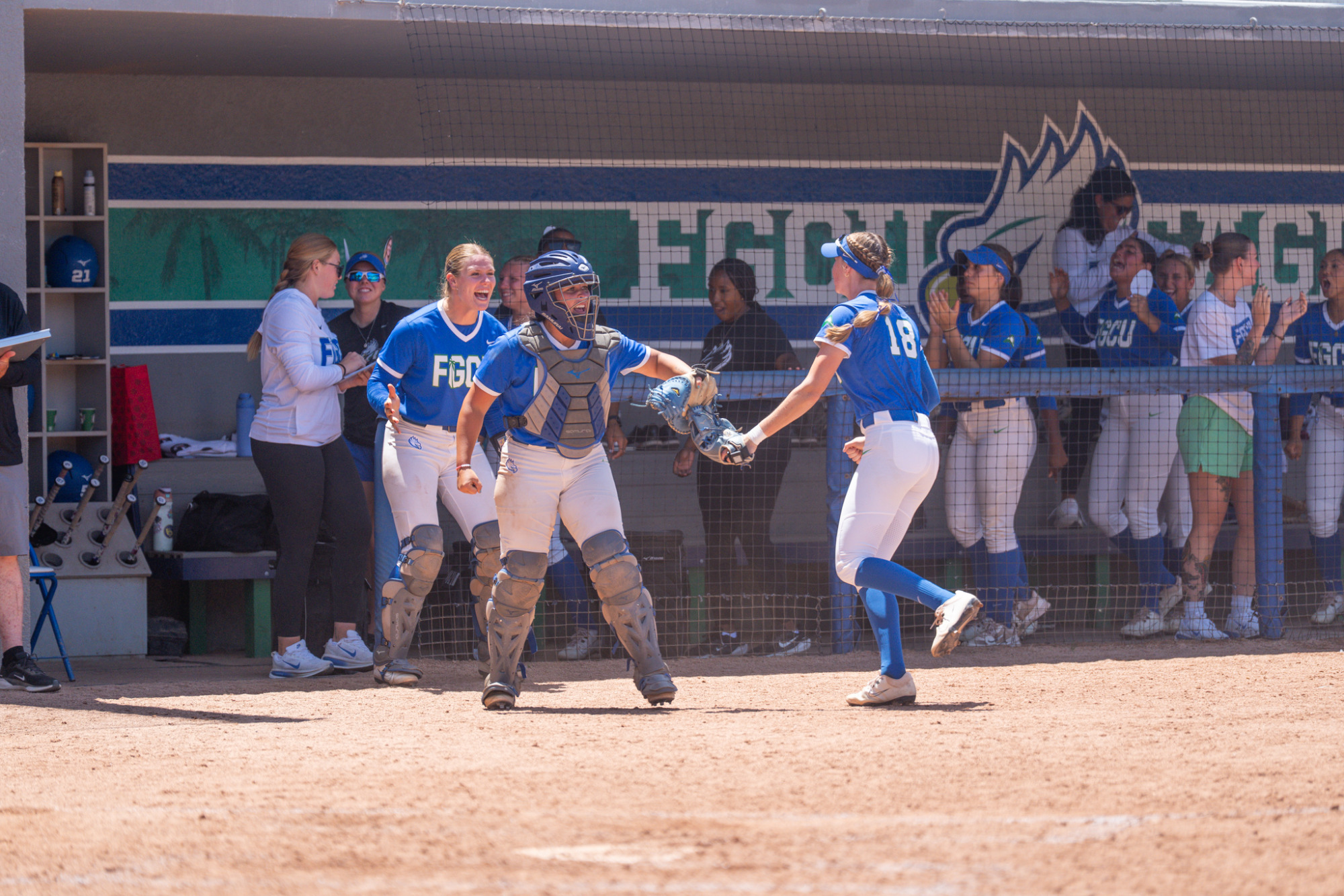Maddox Thomas, Sietkse Drijvers celebrate with Nikki Gibson after a 1-2-3 double play against Queens