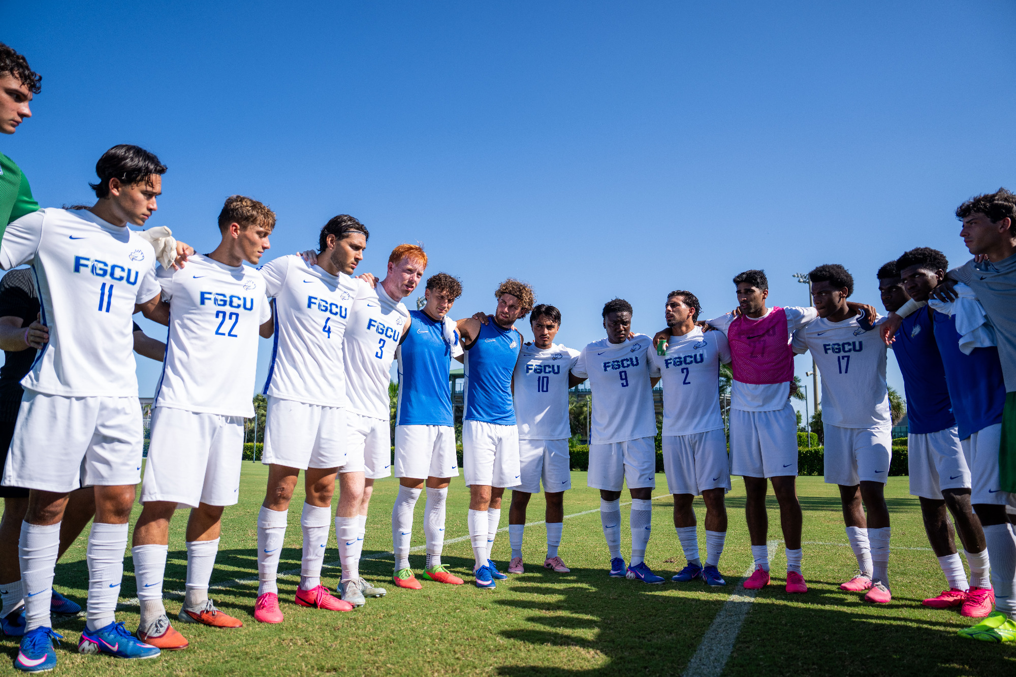 FGCU men's soccer huddles before its exhibition against Tampa