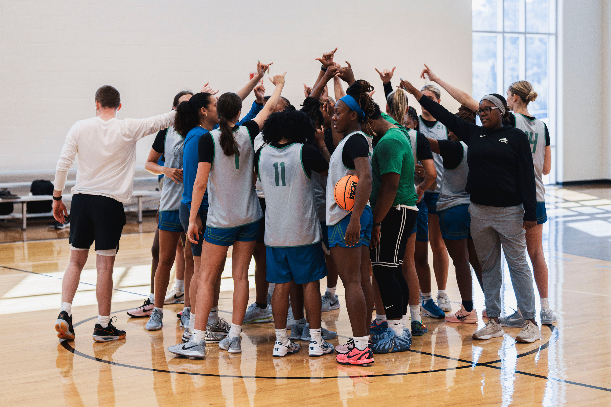 FGCU women's basketball huddles during a summer practice