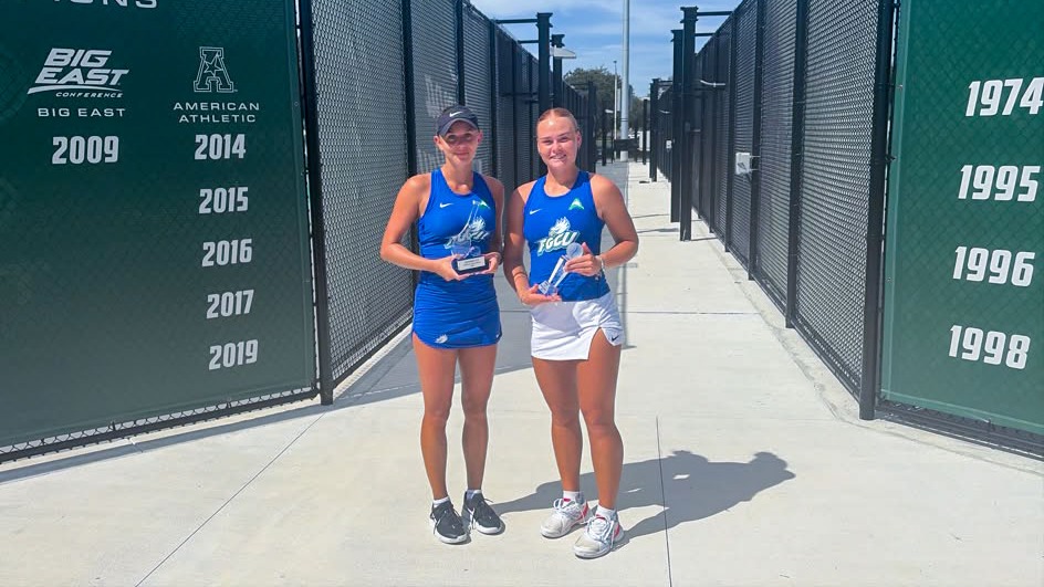 Nora Svensson (left) and June Bjork hold up their Bedford Cup singles champion and runner-up trophies, respectively, at the conclusion of the 2026 Bedford Cup. Svensson's win marked the first time an FGCU player has won the singles championship at the Bedford Cup.