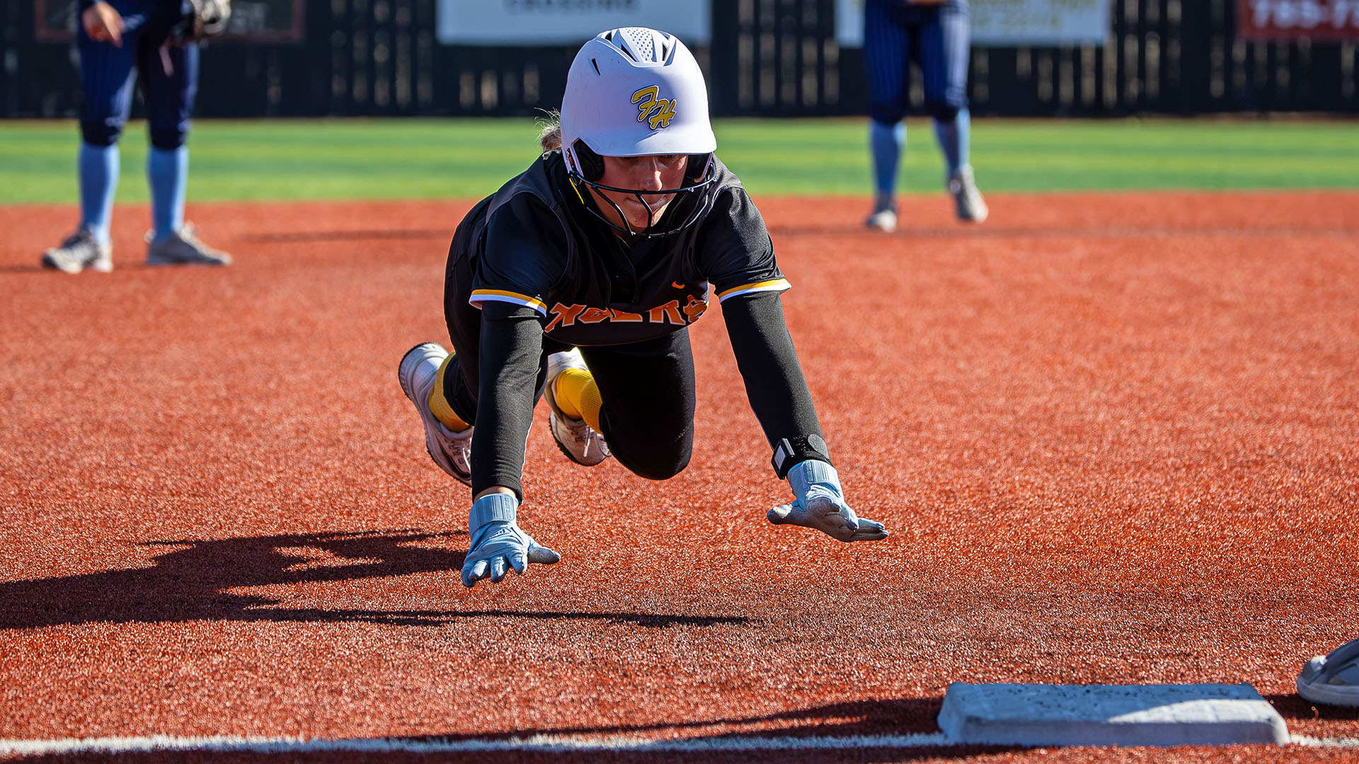 Hannah Green dives head first into third base on a steal attempt