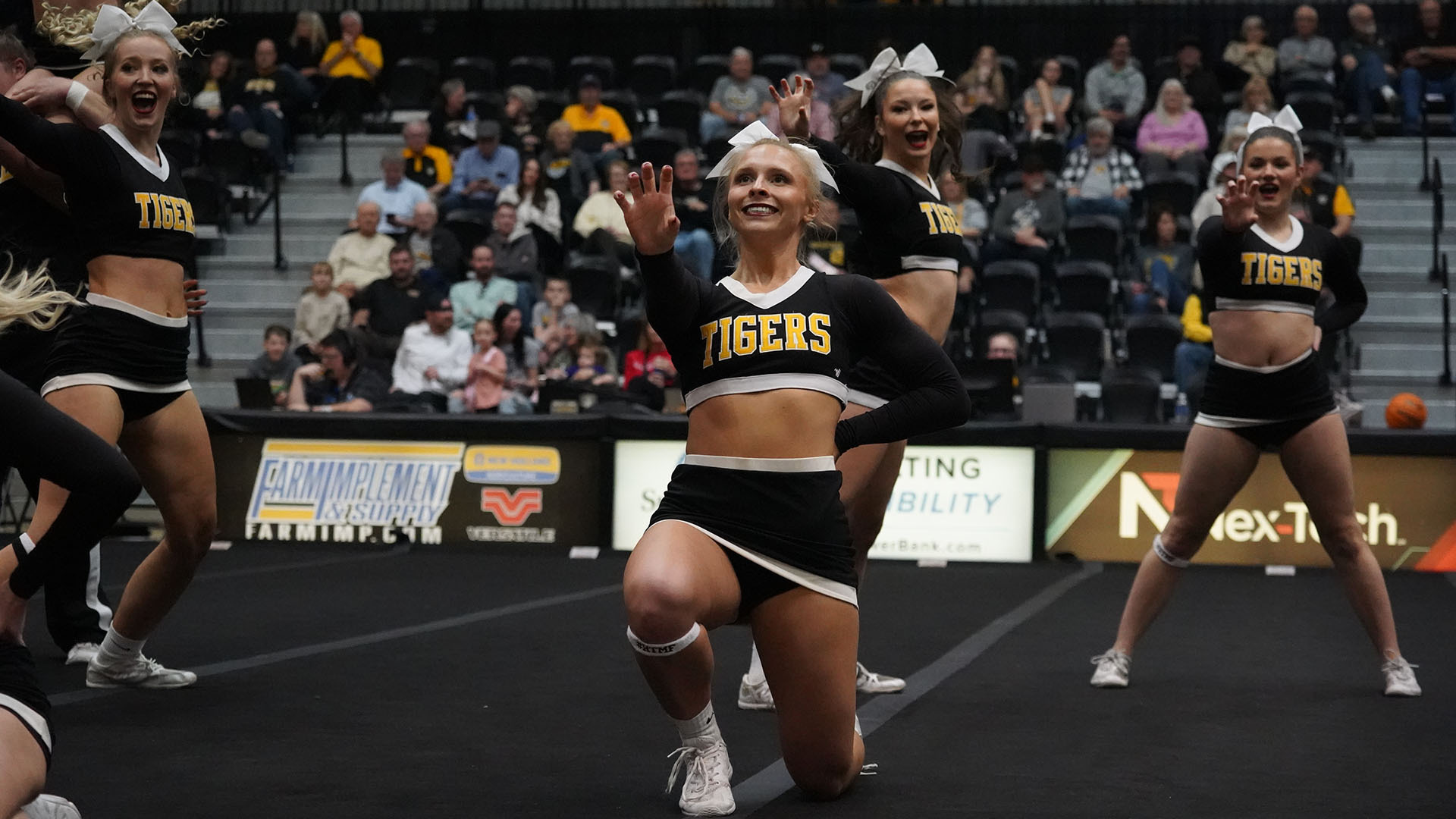 Cheer squad performing during halftime of a basketball game