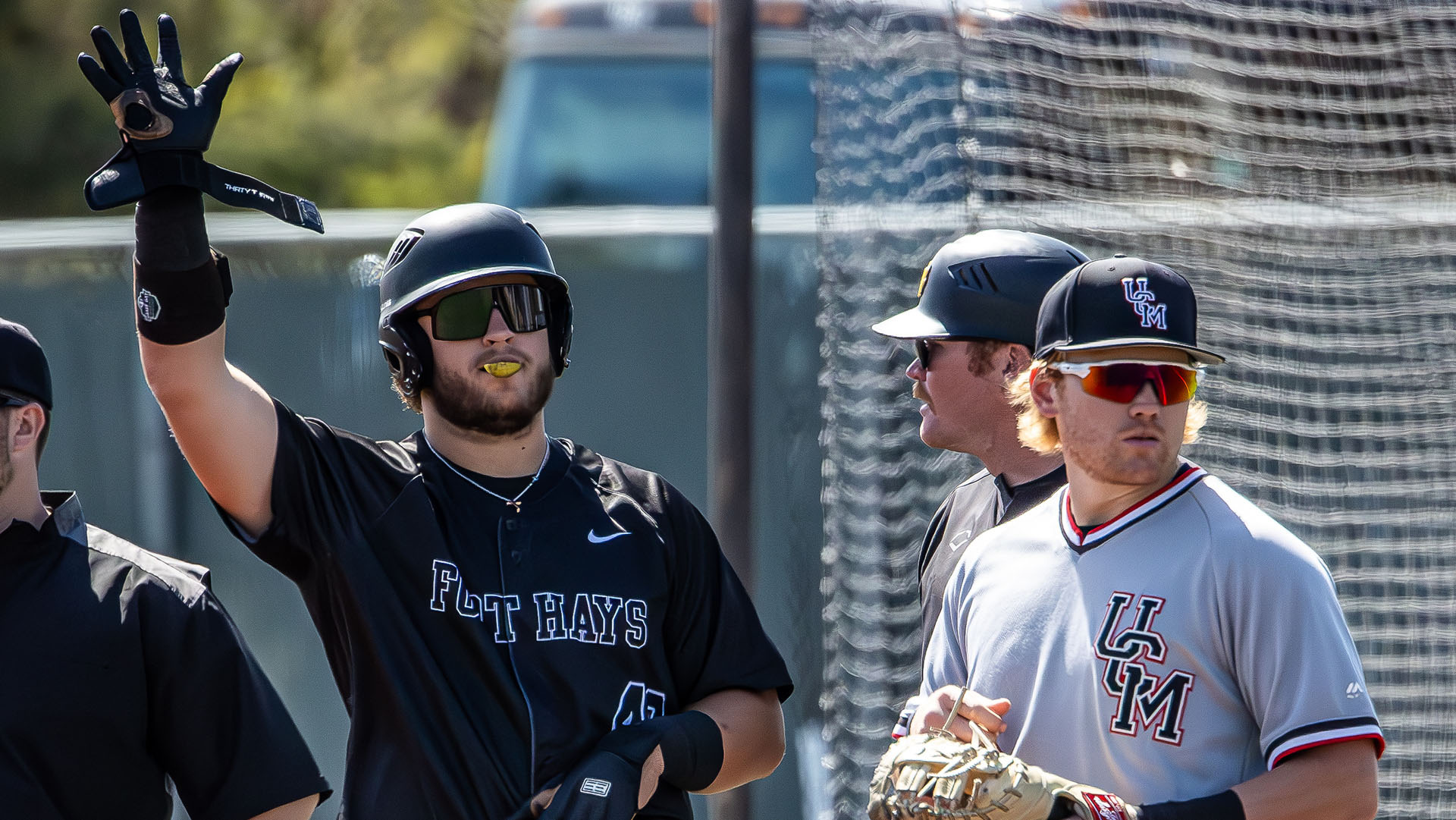 Garretson Cook waves back to the dugout from first base after recording a hit against Central Missouri