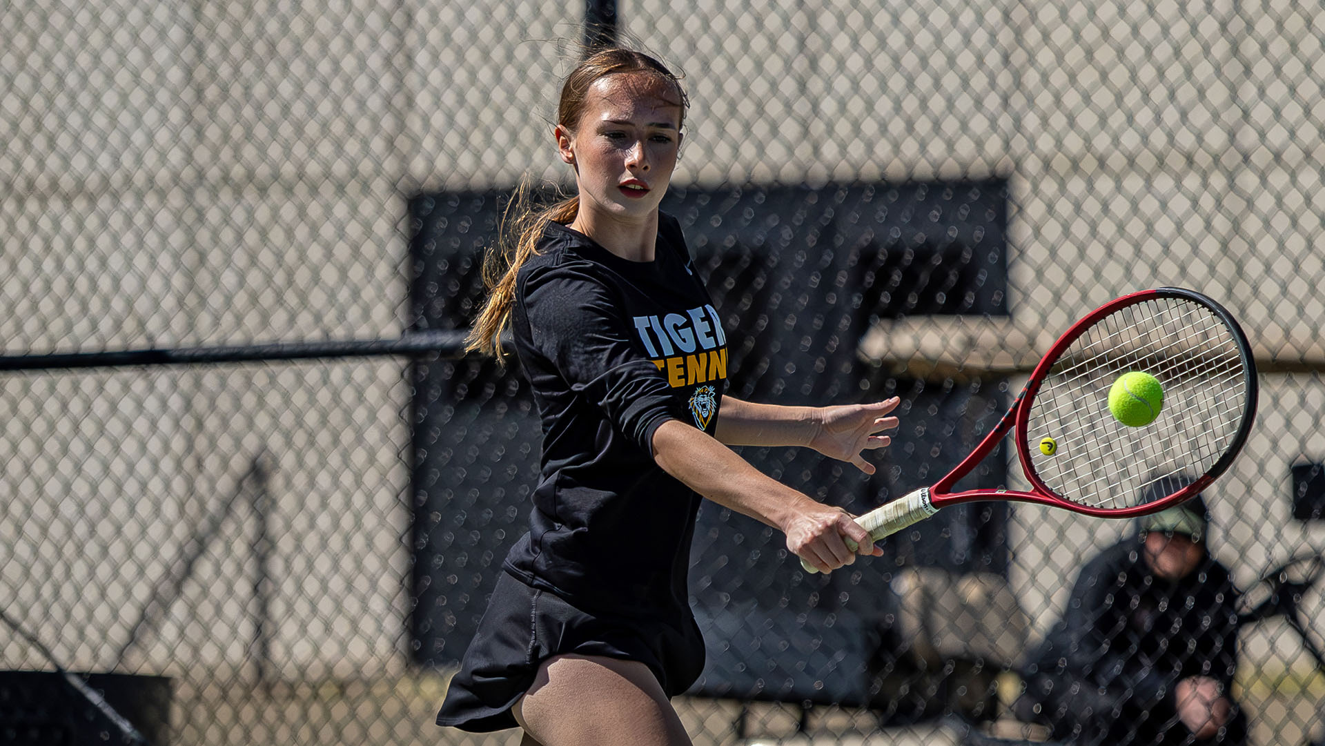 Bethan Gill hits a backhand return shot during competition