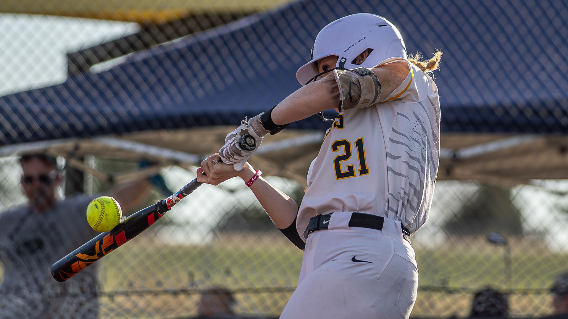 Lilly Mohr hits a ball during a softball game at Tiger Stadium in Hays
