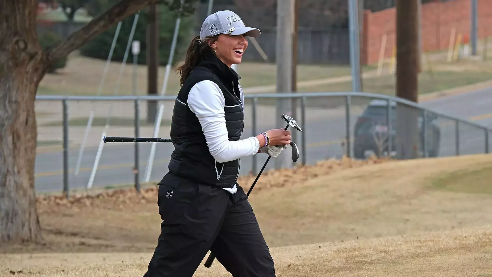 Avery Blasi reacts after hitting a shot near the green