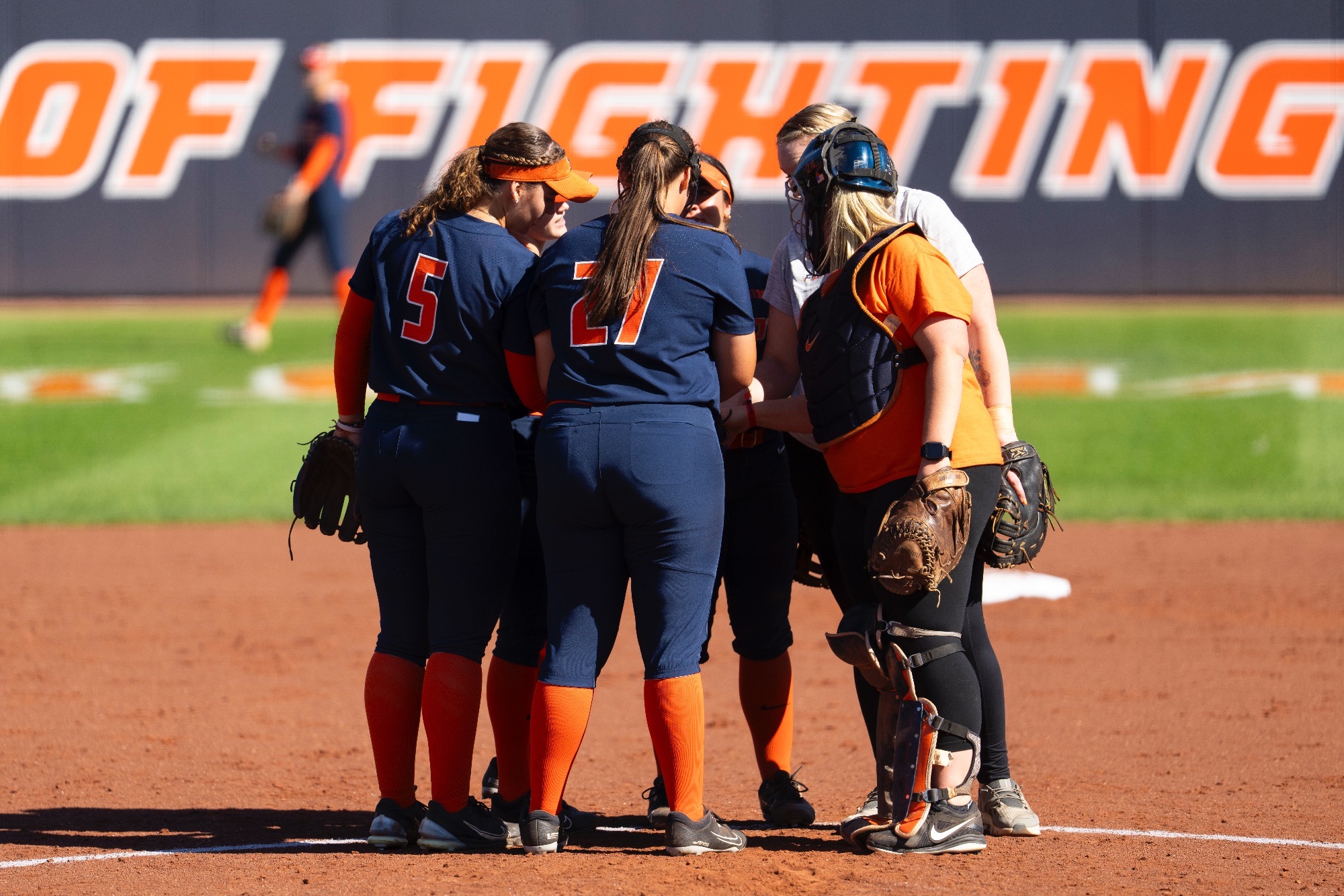 Softball huddles in the circle