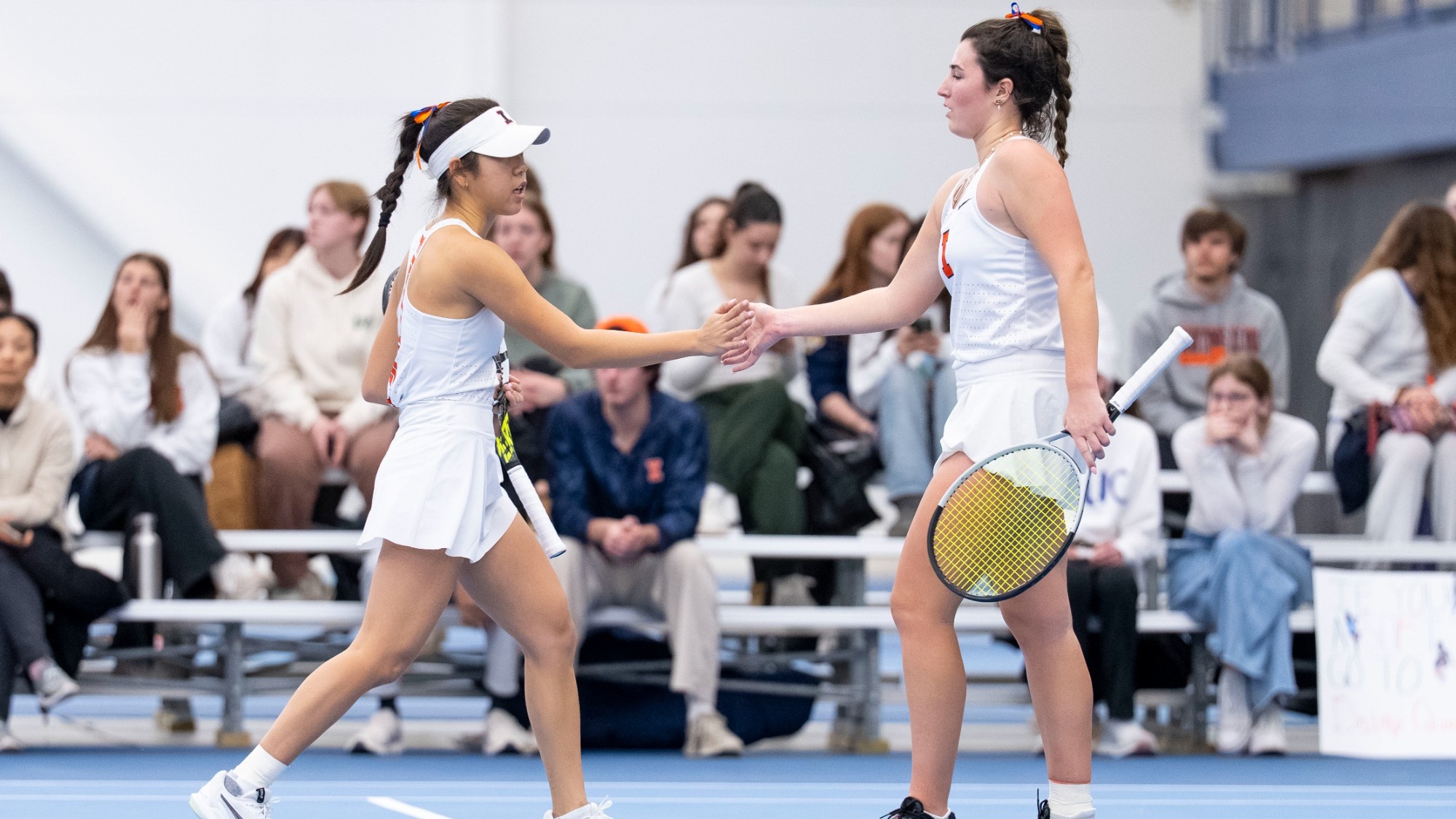 CHAMPAIGN, IL - February 20, 2026 - Alice Xu, Tess Bucher during the match between the Wisconsin Badgers and the Illinois Fighting Illini at Atkins Tennis Center in Champaign, IL. Photo By Ashley Ray/Fighting Illini