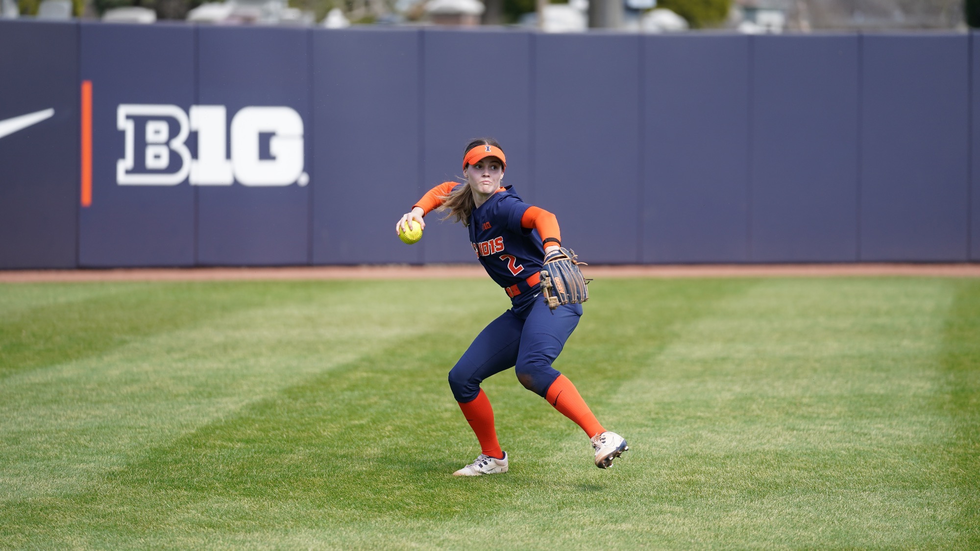 Ava Moore throwing a softball