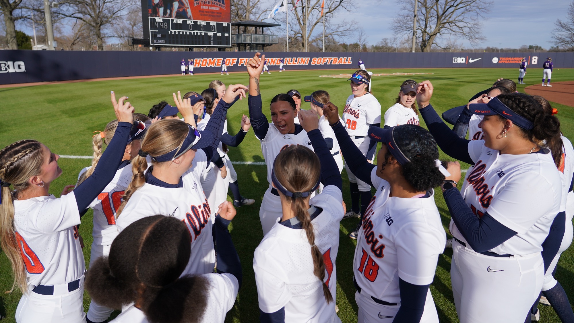 Illinois softball huddles on the field