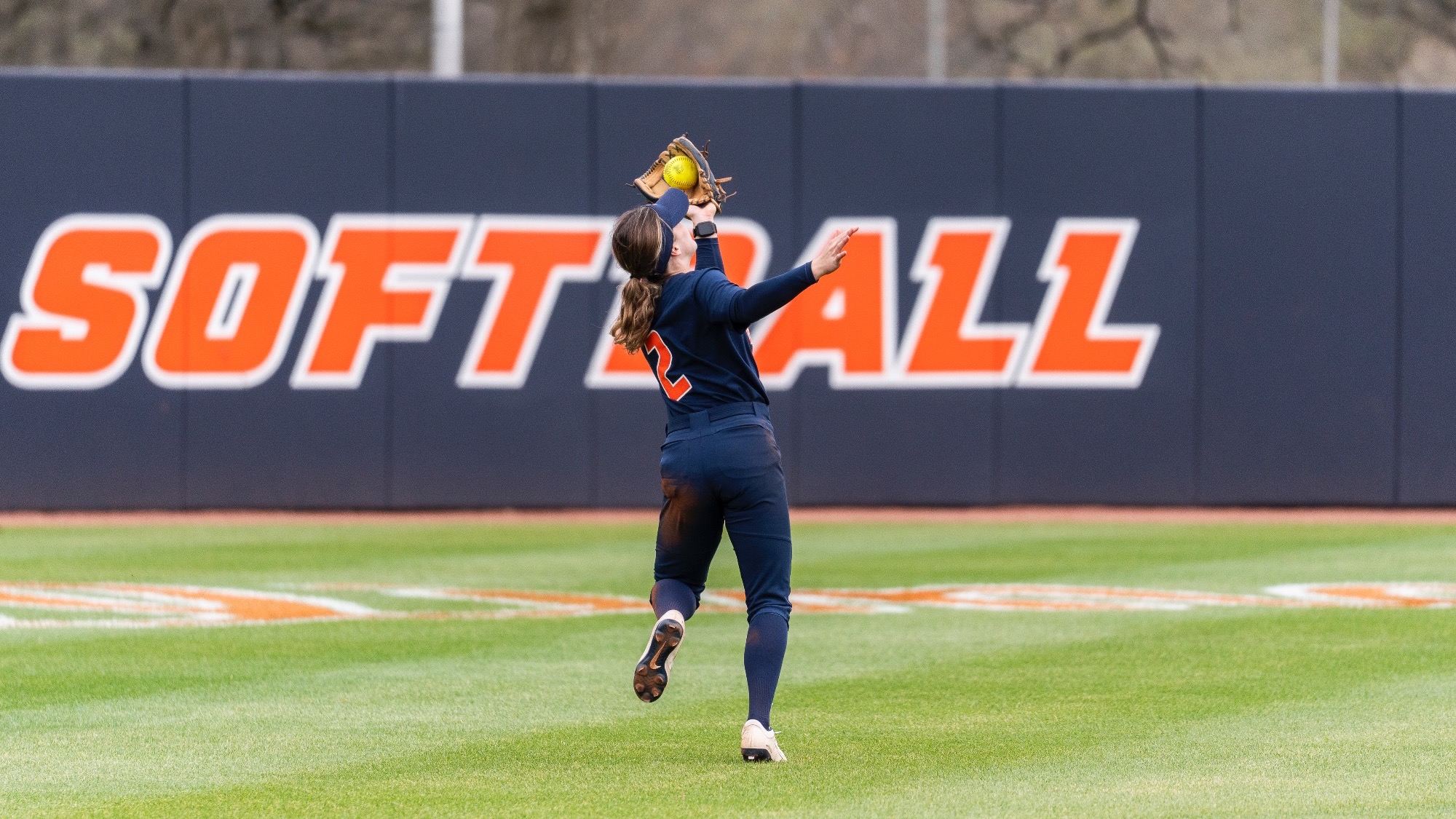 Ava Moore catches a ball while running at Eichelberger Field in Urbana, Illinois.