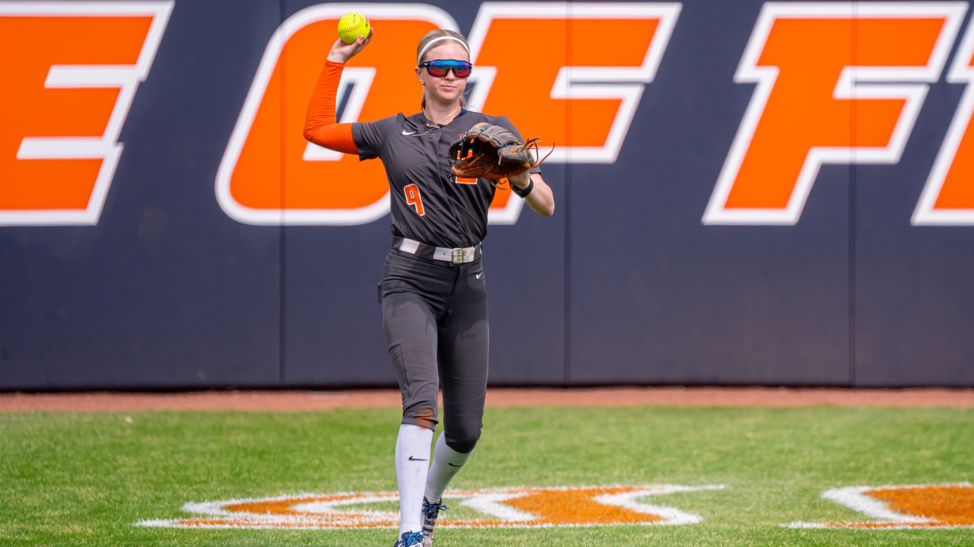 Alaina Miller throwing softball from the outfield at Eichelberger Field in Urbana, Illinois.