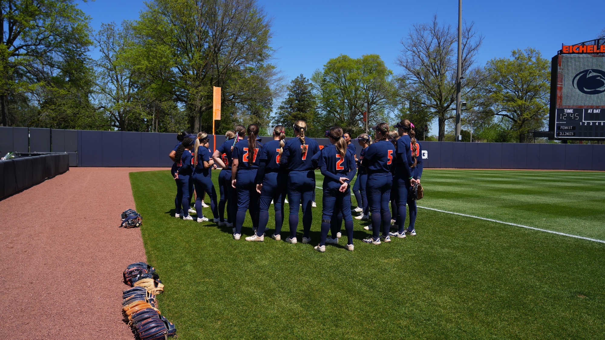 Illinois softball huddles on Eichelberger Field in Urbana, Illinois.