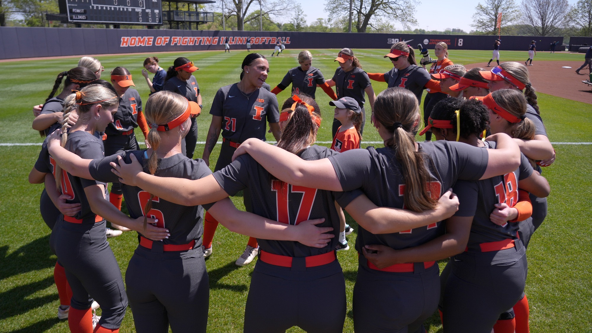 Fighting Illini softball huddles prior to the game at Eichelberger Field.