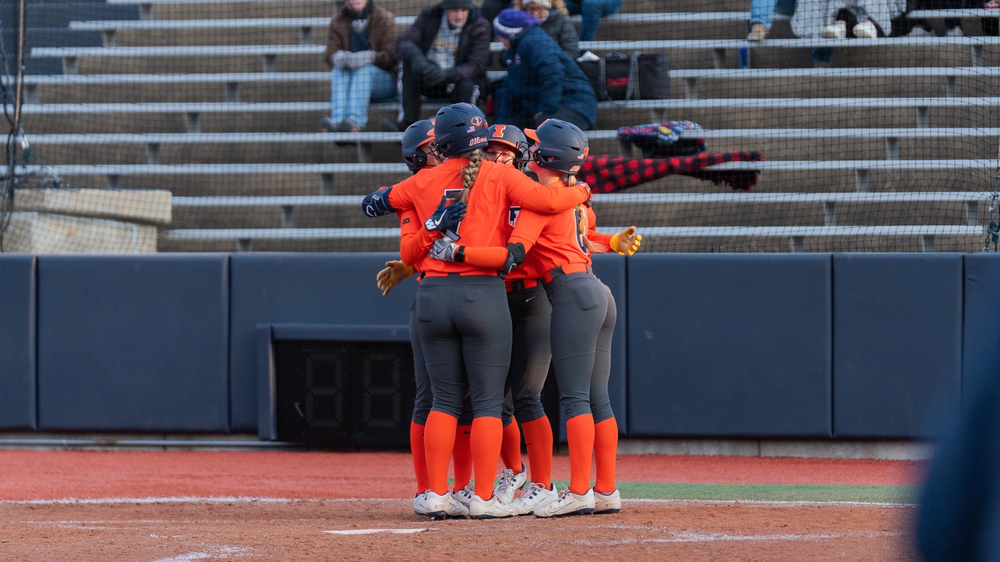 Illinois softball teammates hug after scoring