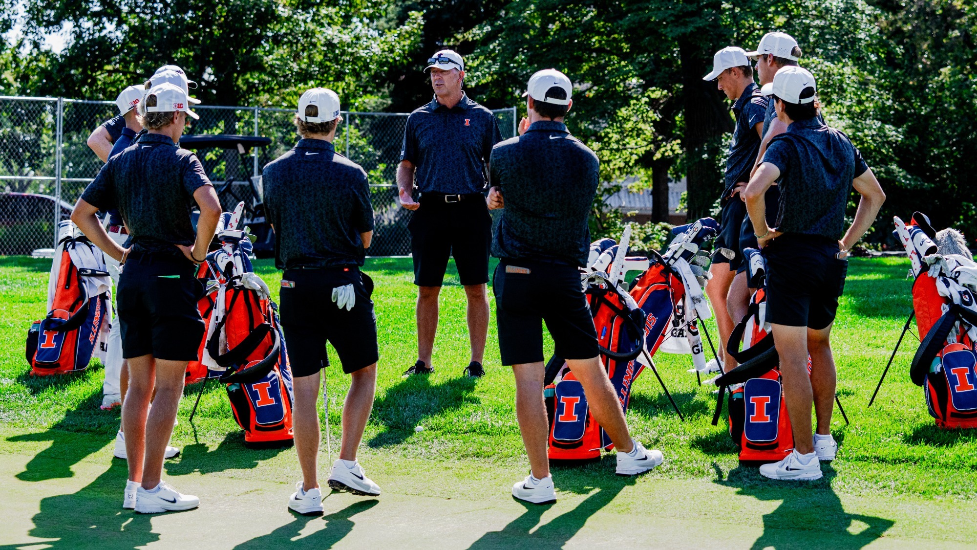 Men's golf team huddle