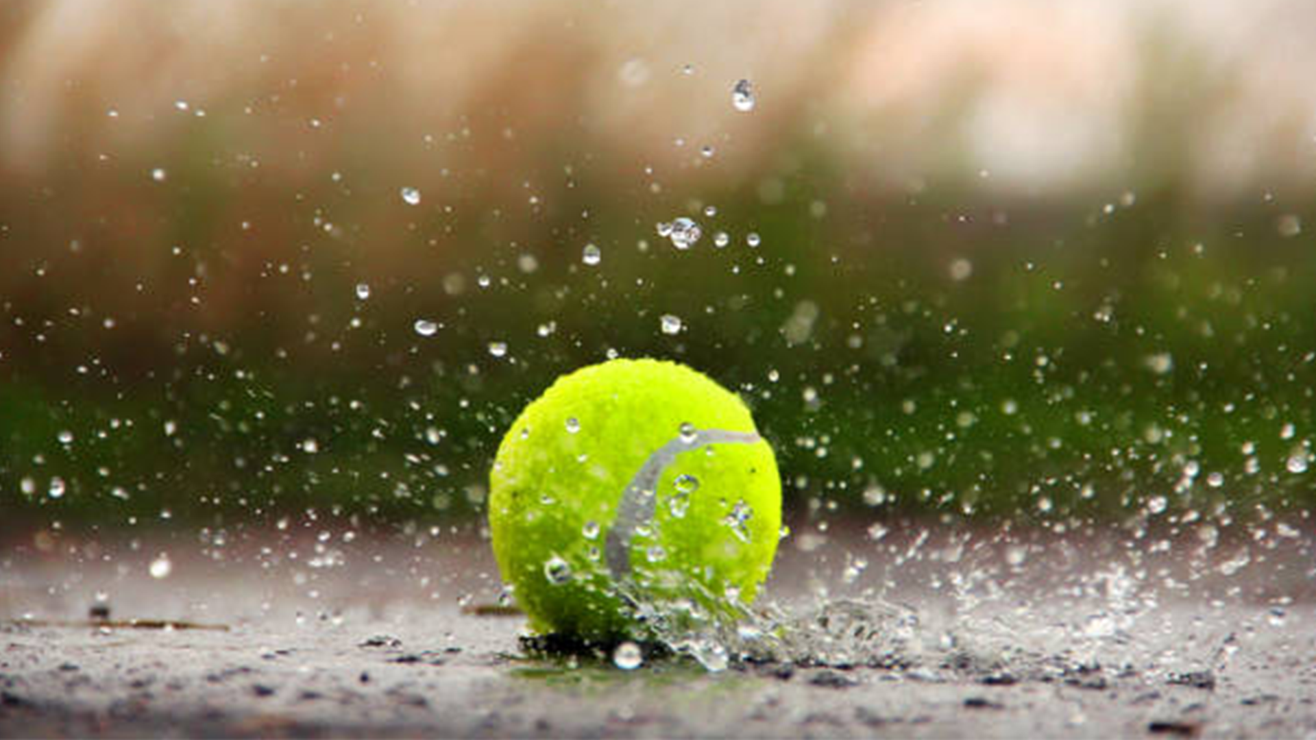 Tennis ball on court with rain