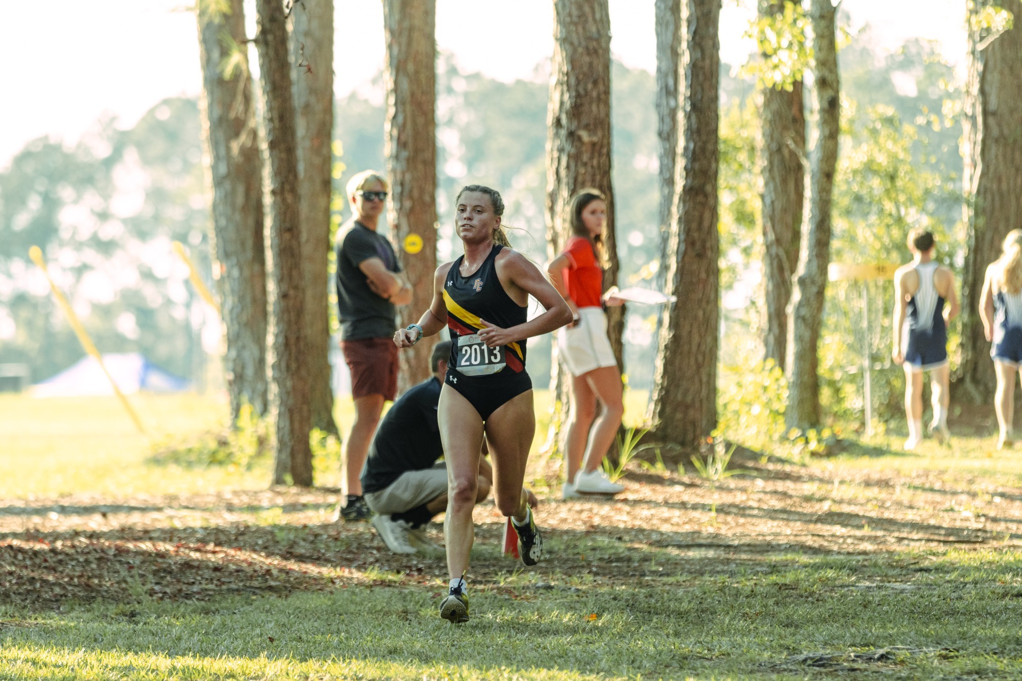 Tori Mills running through the woods