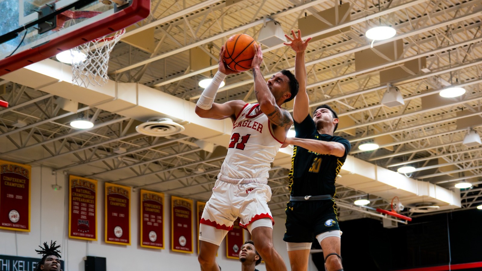 Hoku Fisher avoids a defender as he jumps up for a layup