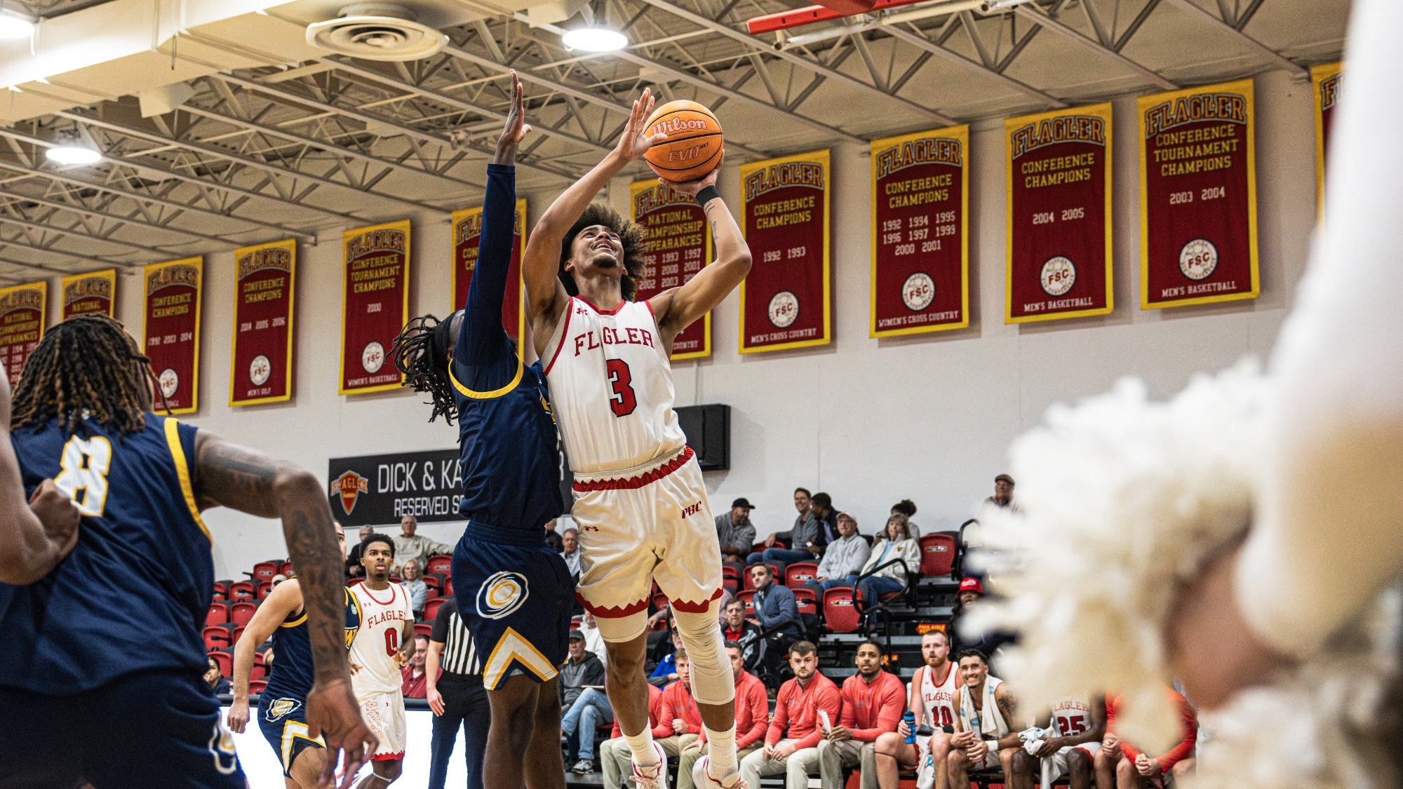 Jordan Smith jumps up for a layup with a defender on his side.