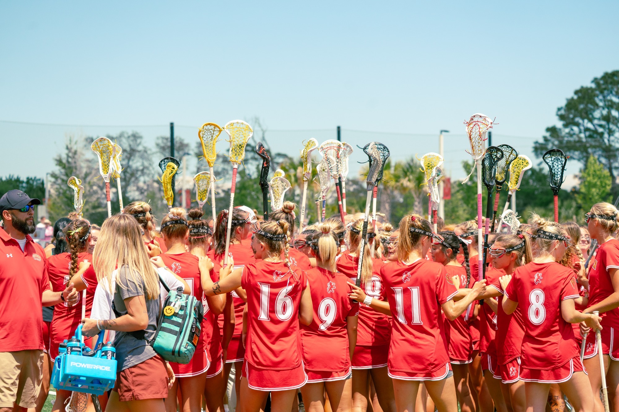 Saints holding their sticks up in a huddle