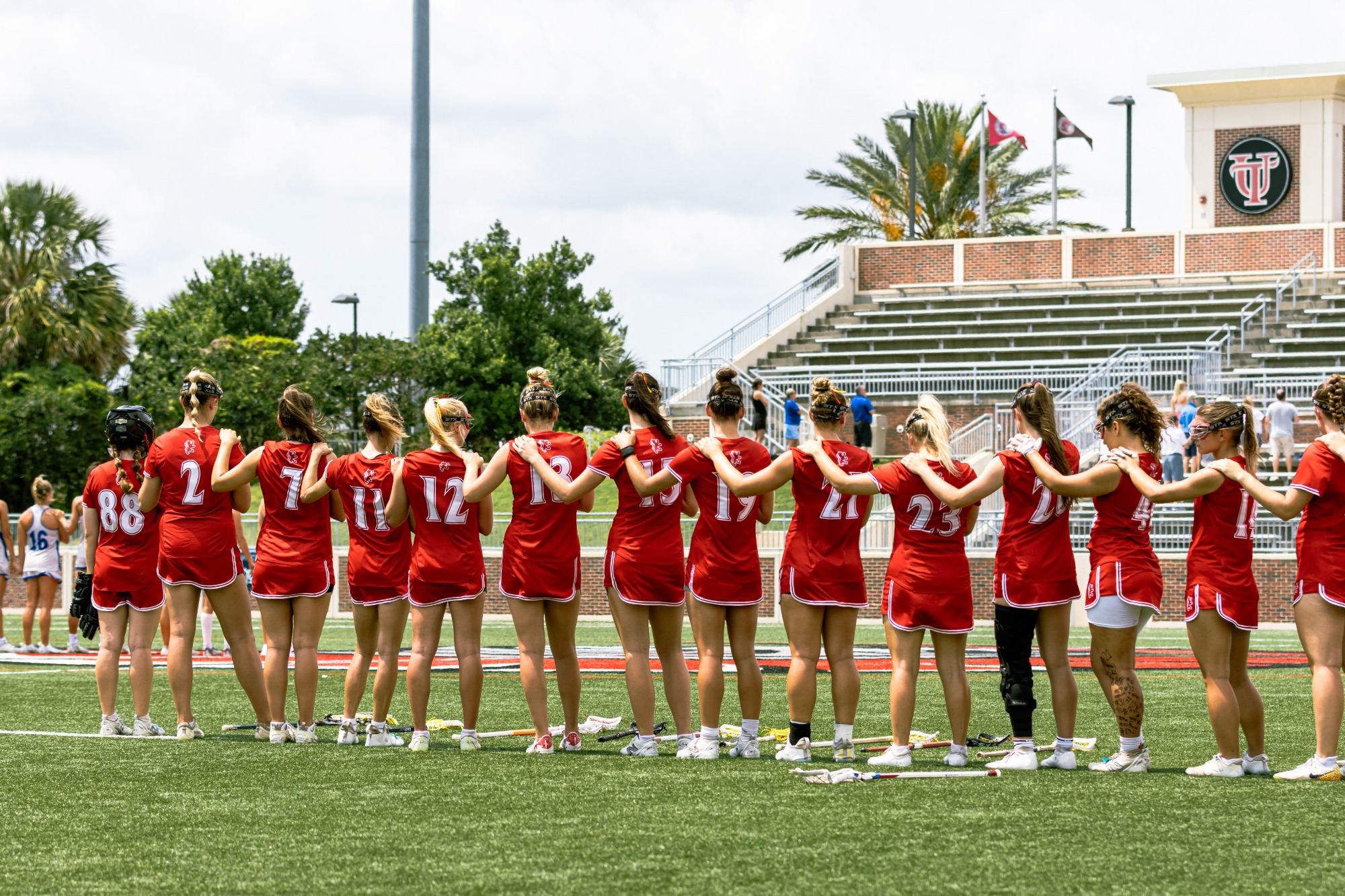 Women's lacrosse saluting the flag