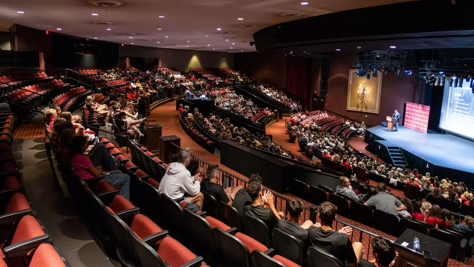 Student-athletes sit in the Lewis Auditorium for the Welcome Back event