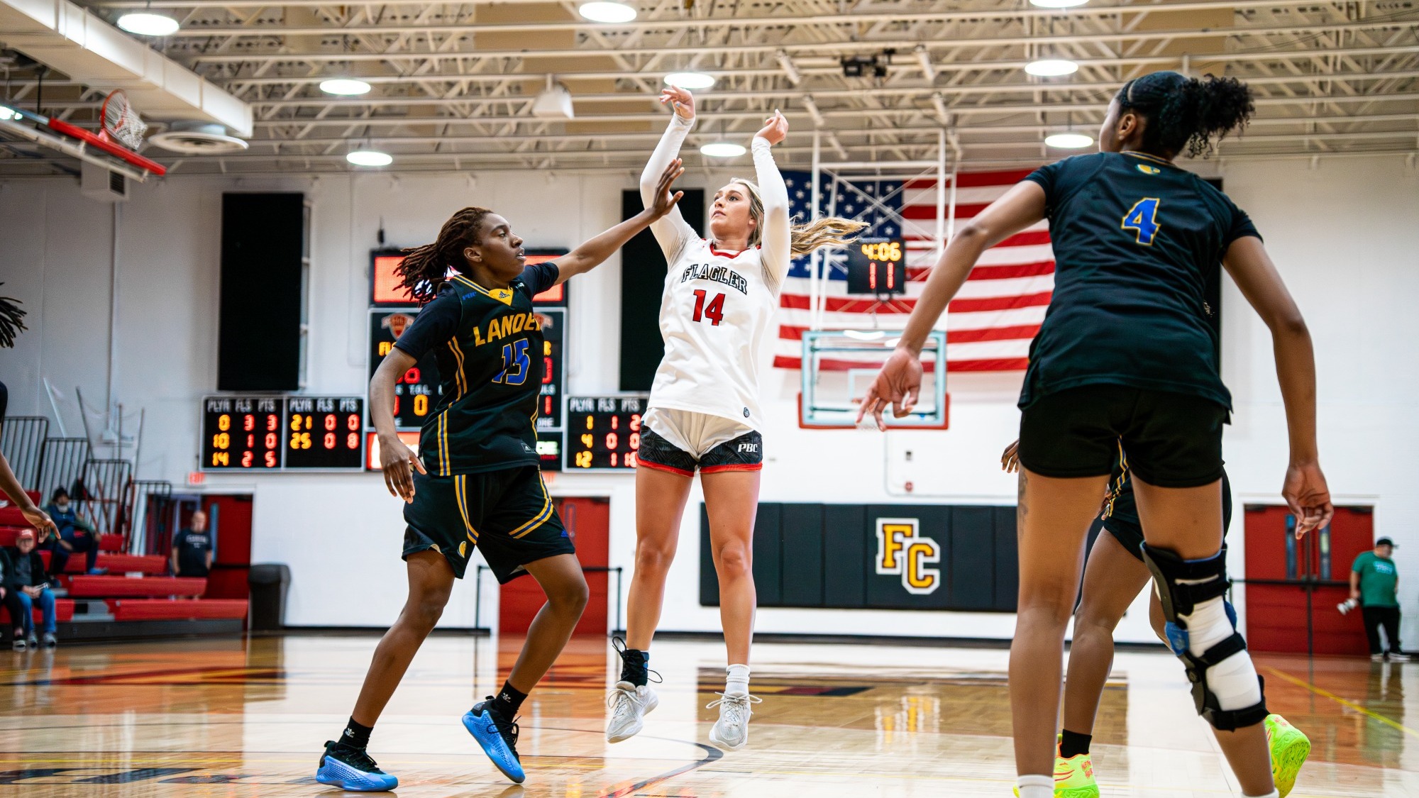 Marley Smith shots a jumper with defeners closing in