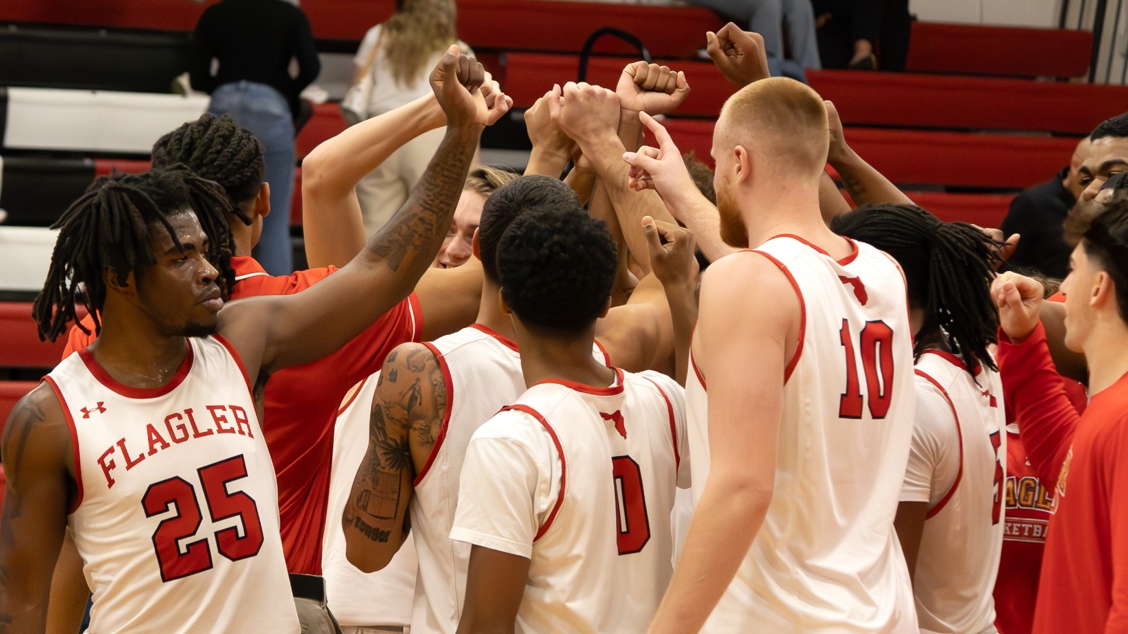 Men's basketball players break the huddle at a timeout
