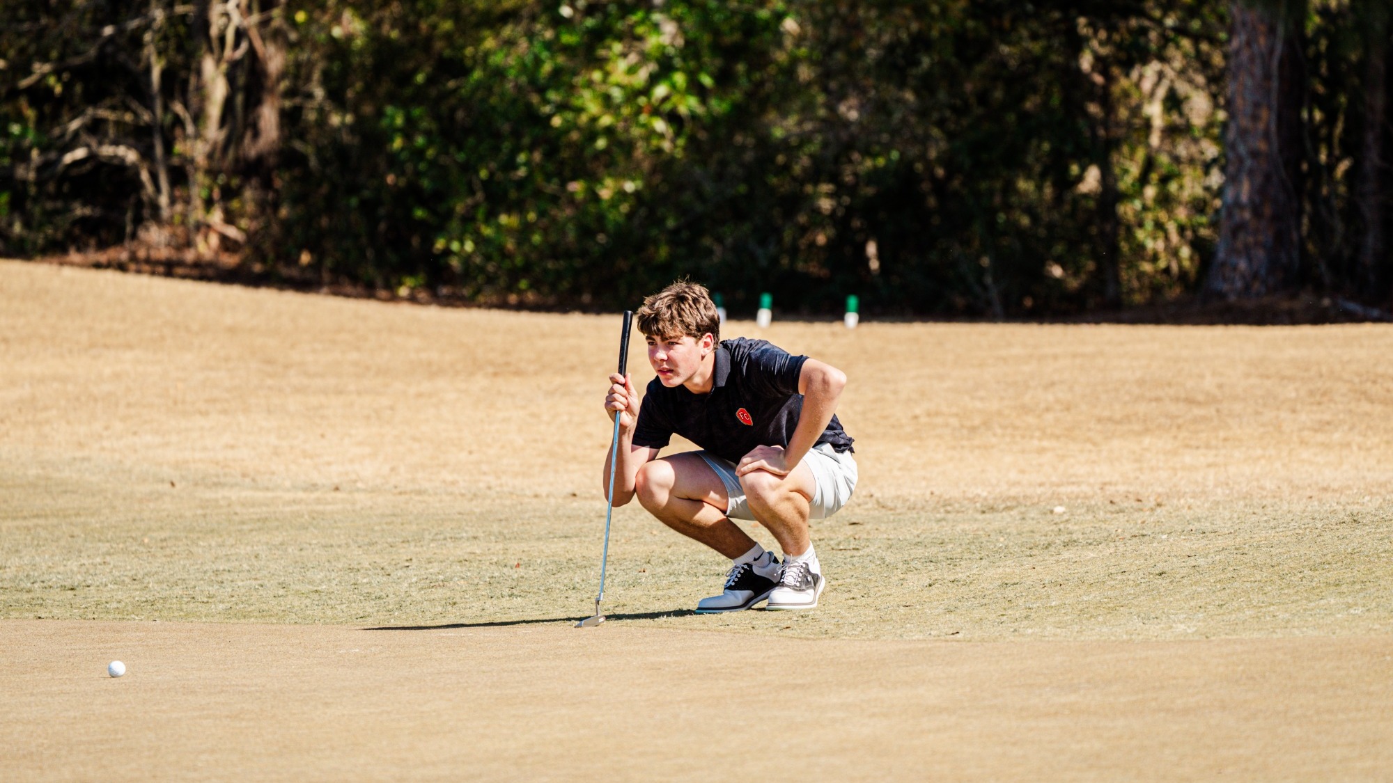PJ Herron lines up a putt