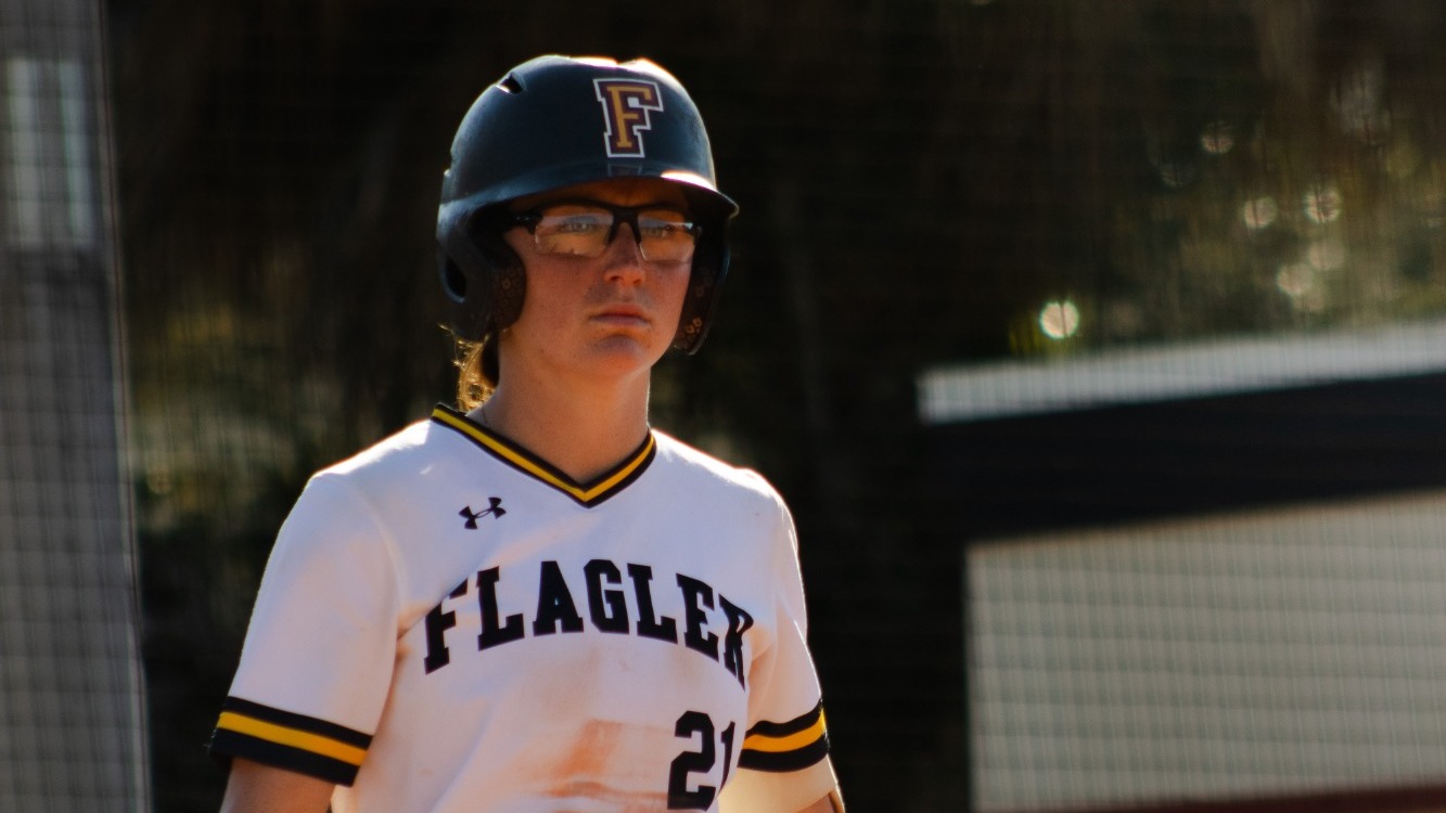 Emily Ricci looks toward right field standing at the plate