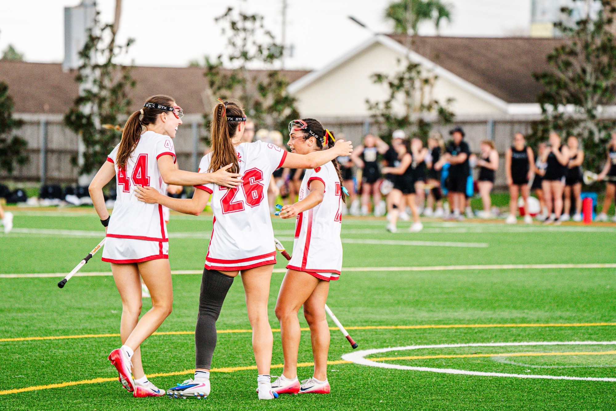 Halford, Wright and Lambros hugging after a goal