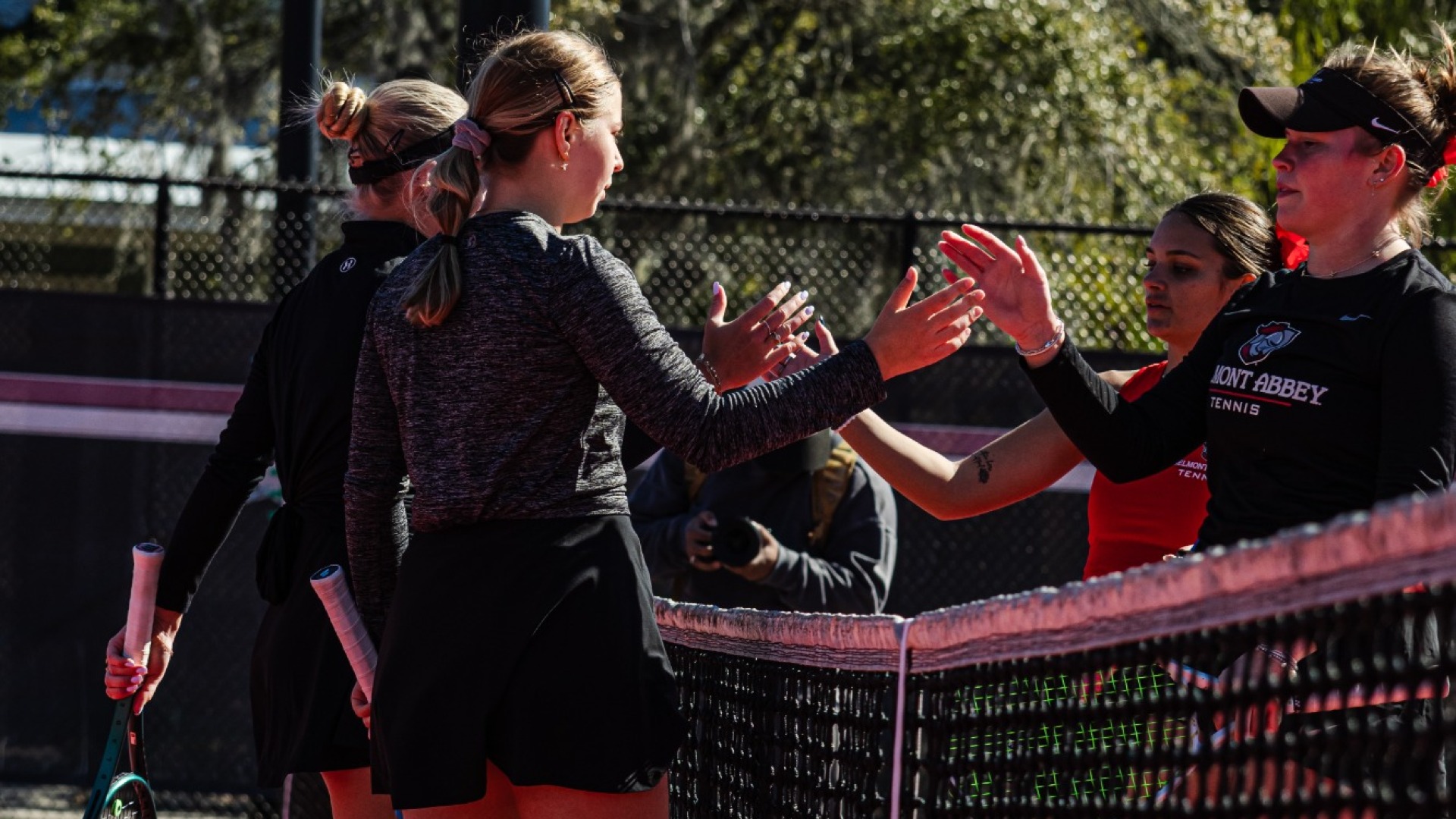 Eryka Kruk and Lea Jakic handshaking their opponents at the net