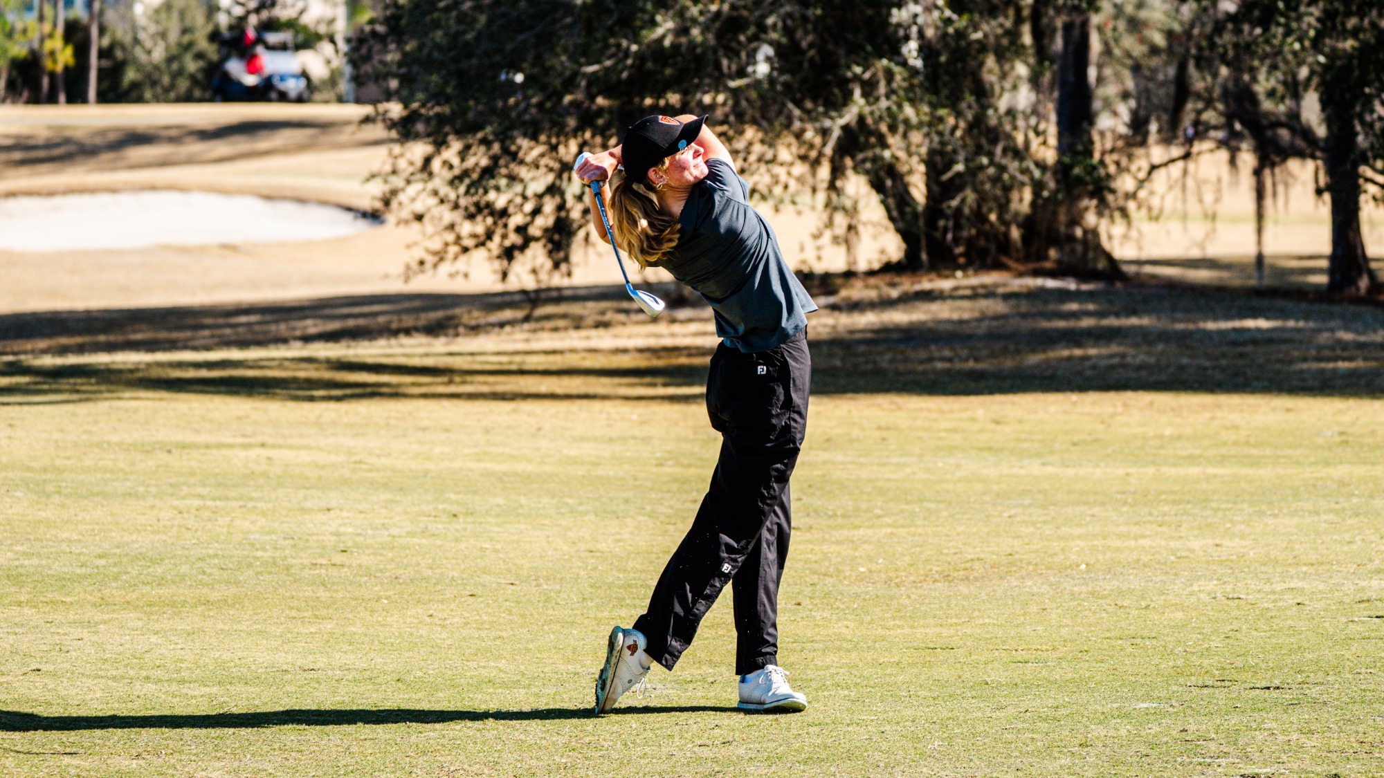 Addison King hits a fairway iron