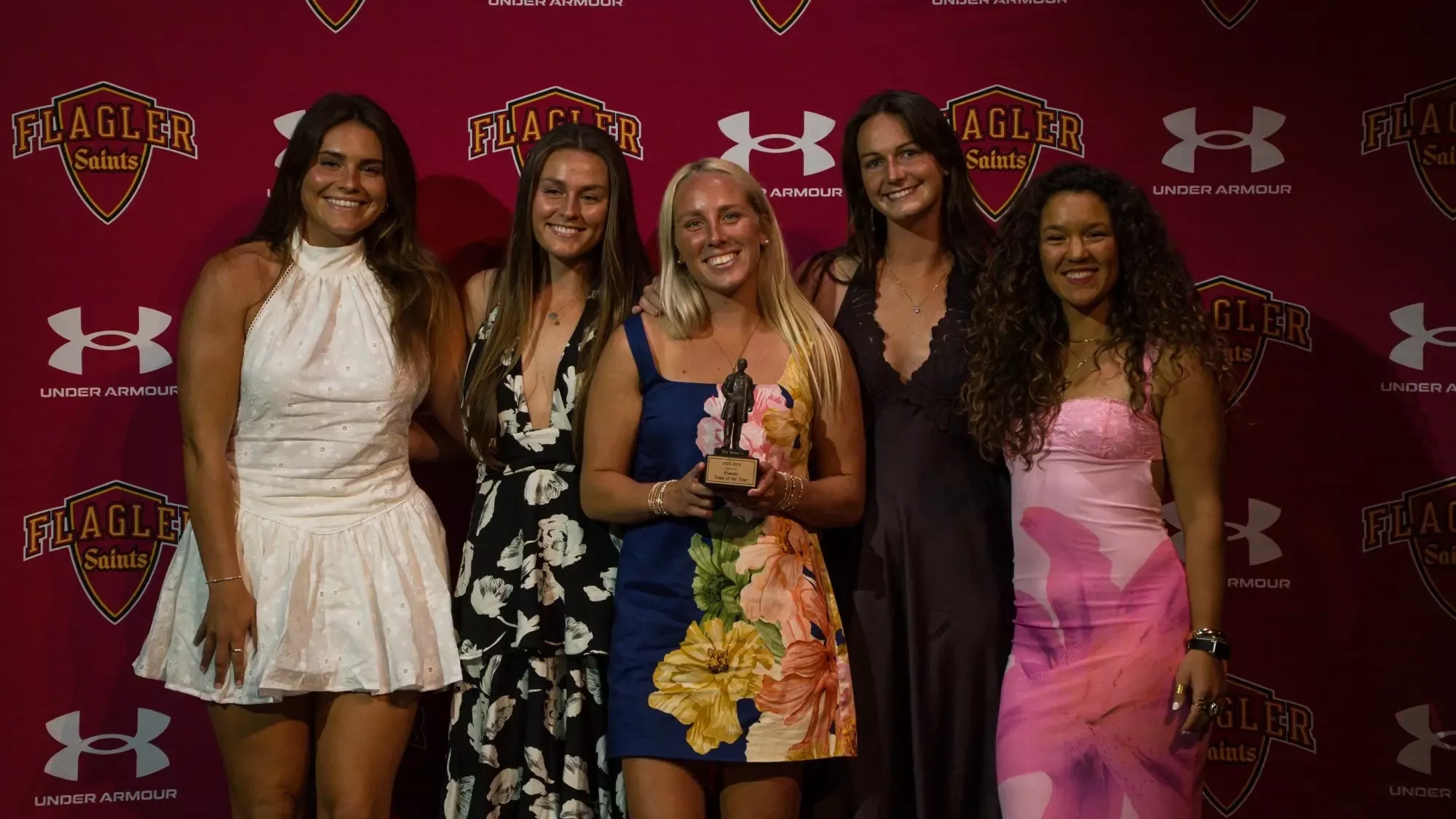 Members of the women's lacrosse team pose with the trophy for the female team of the year