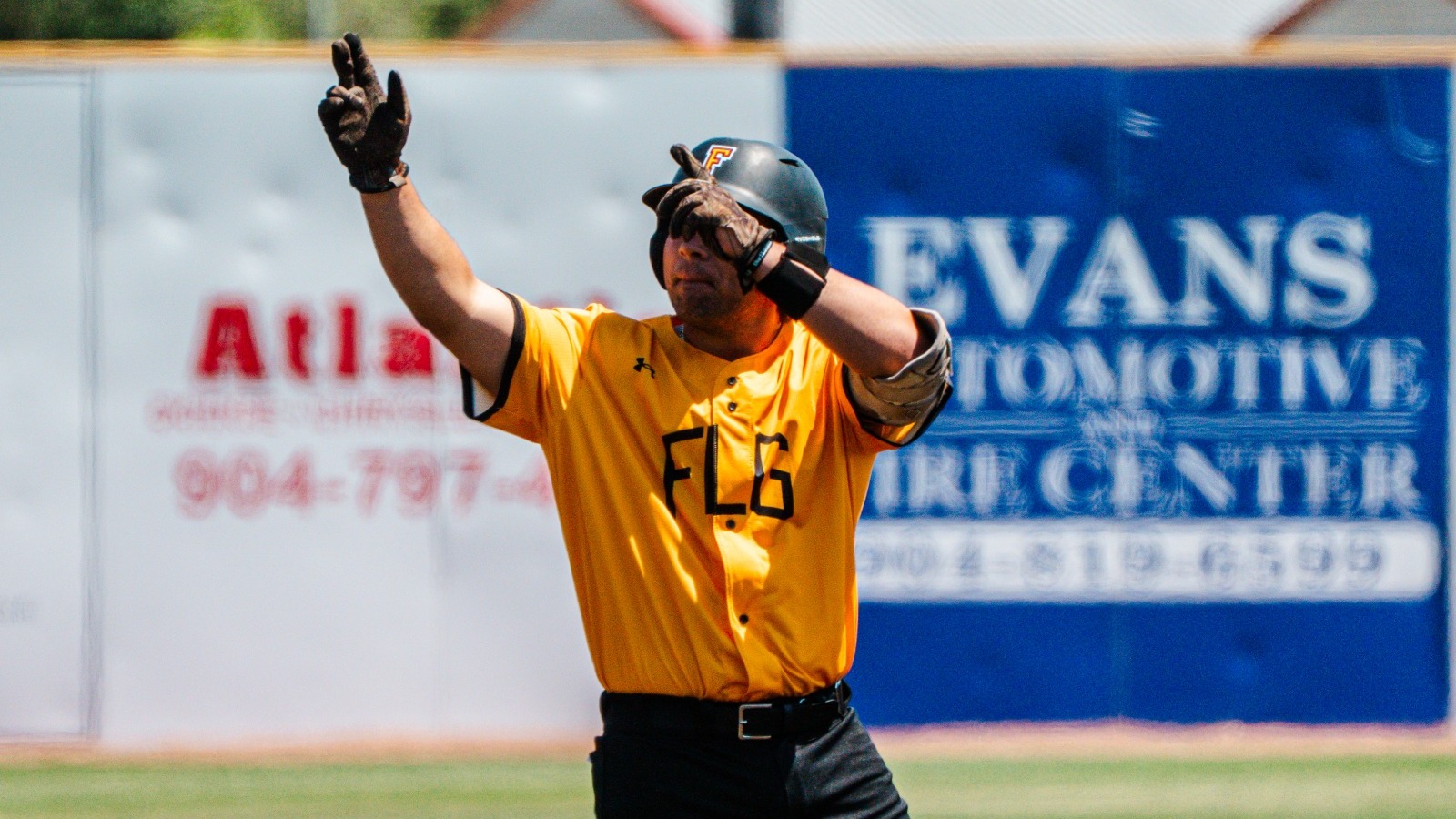 Jesse Sullivan stands at second base pointing to the sky