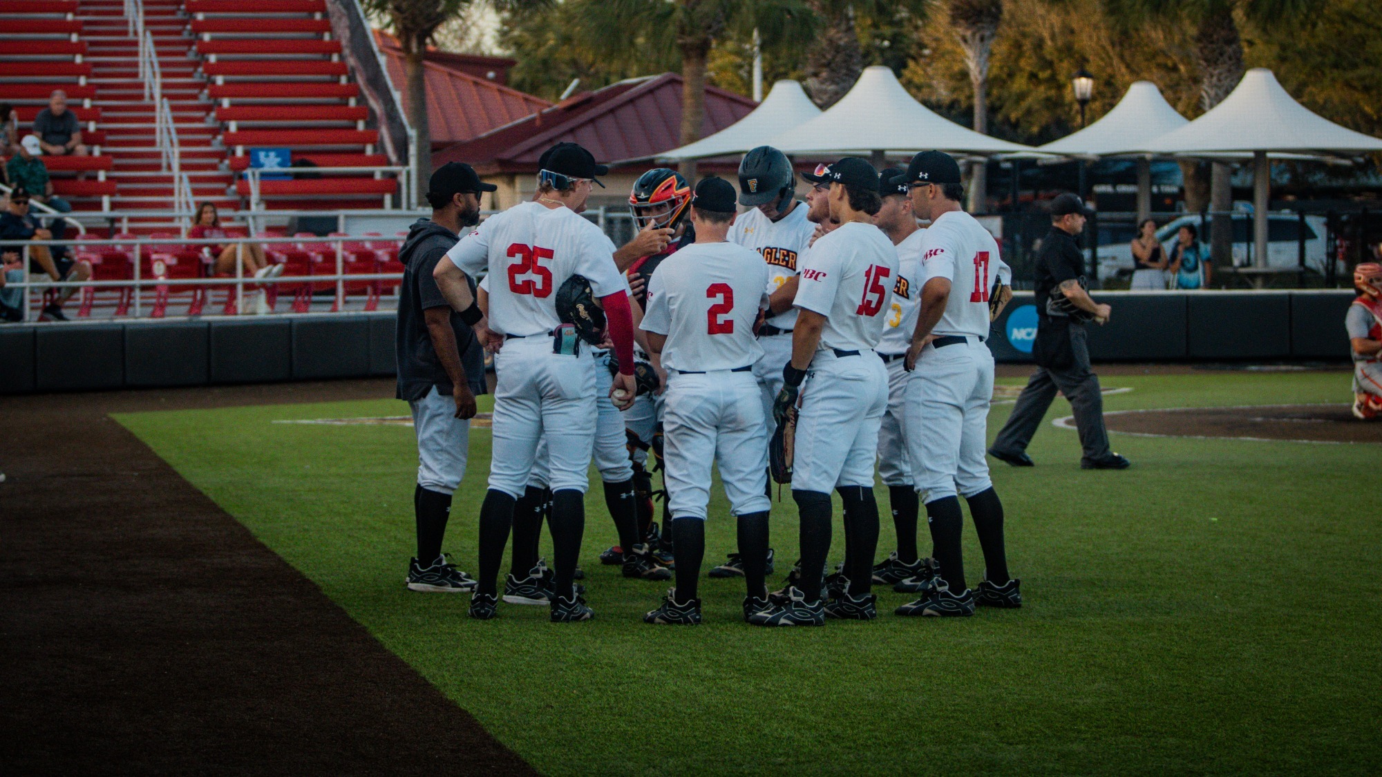 Flagler baseball players meet with the assistant coach