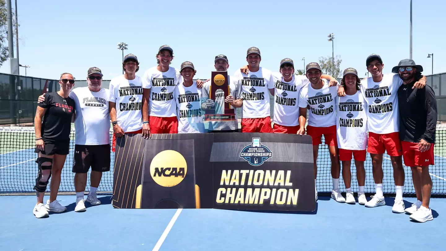 Flagler men's tennis team with the trophy and banner