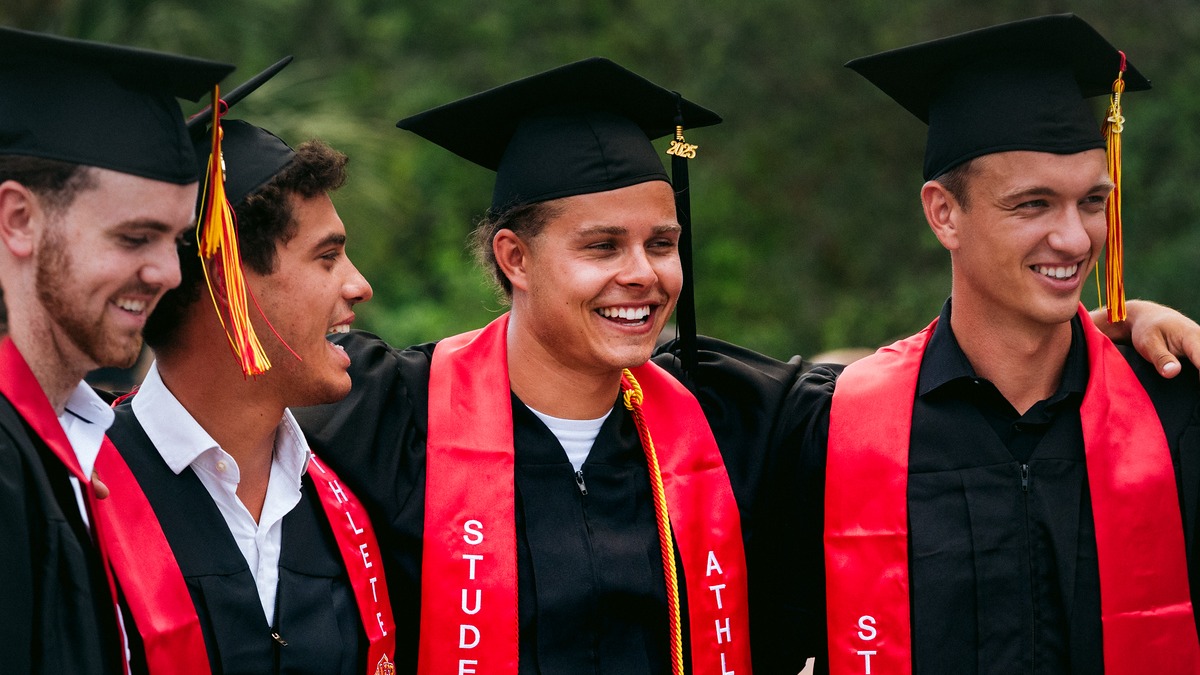 Flagler student-athletes pose for a photo at graduation