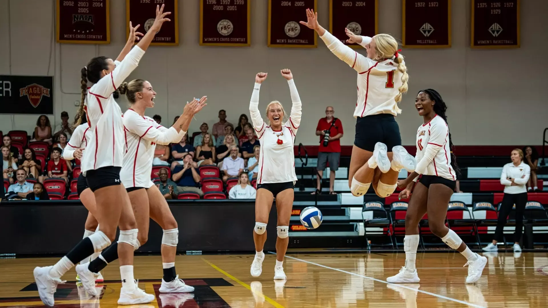 Saints cheering after scoring a point at alumni game