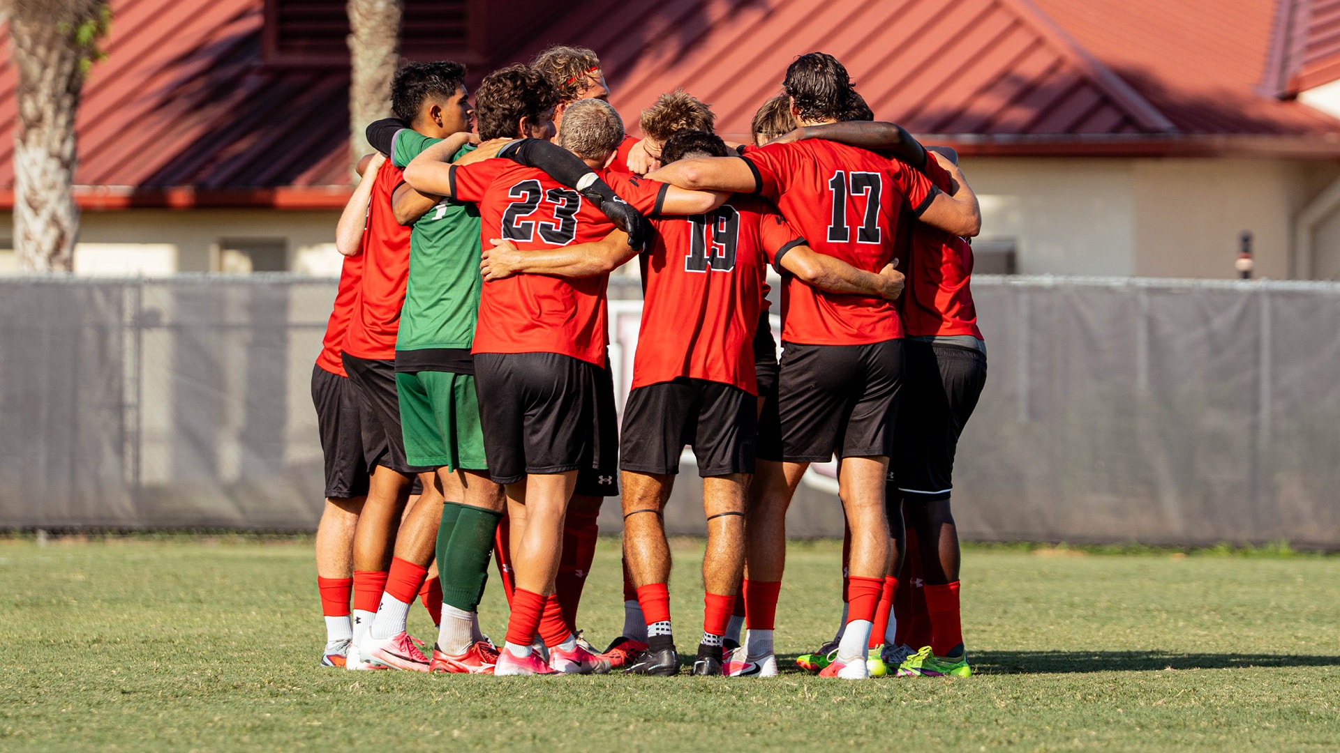 Men's soccer huddle before kickoff against Jacksonville Football Club