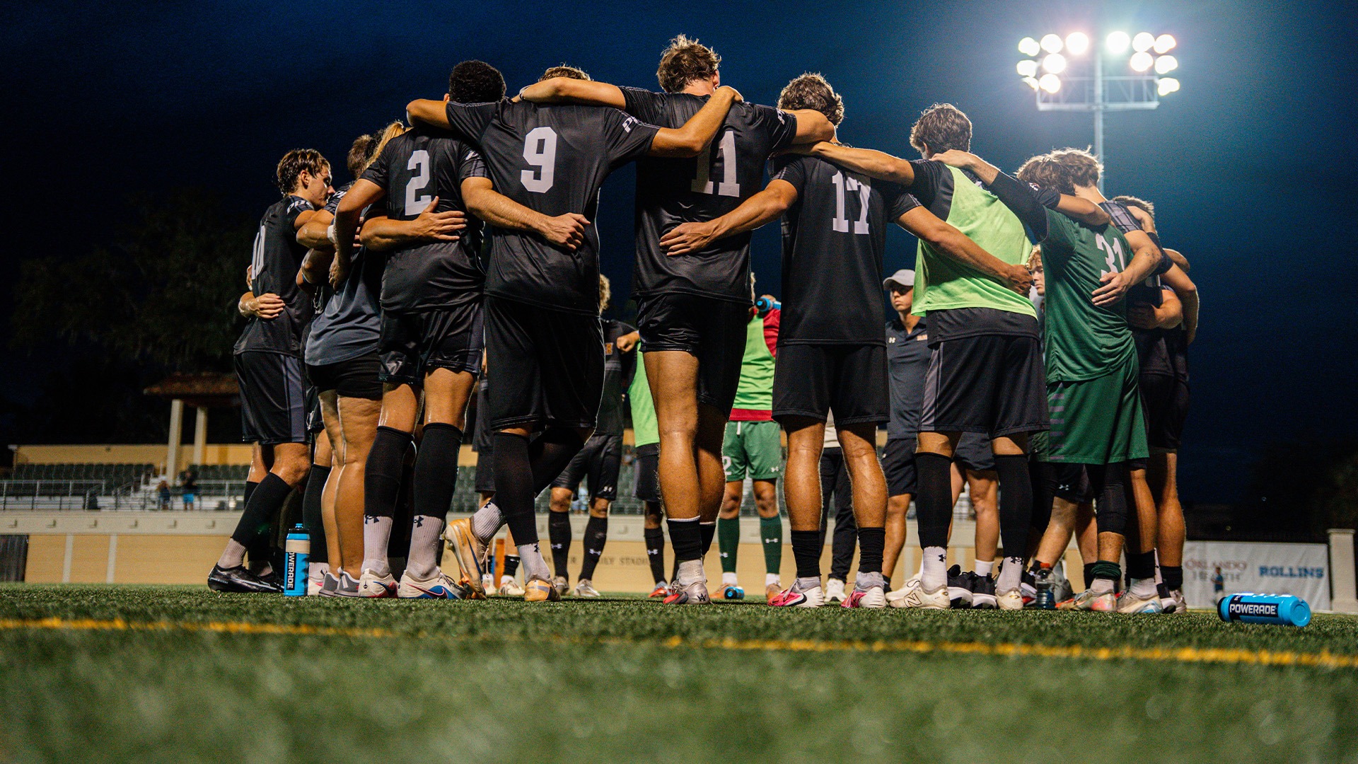 Men's soccer team huddle at Rollins
