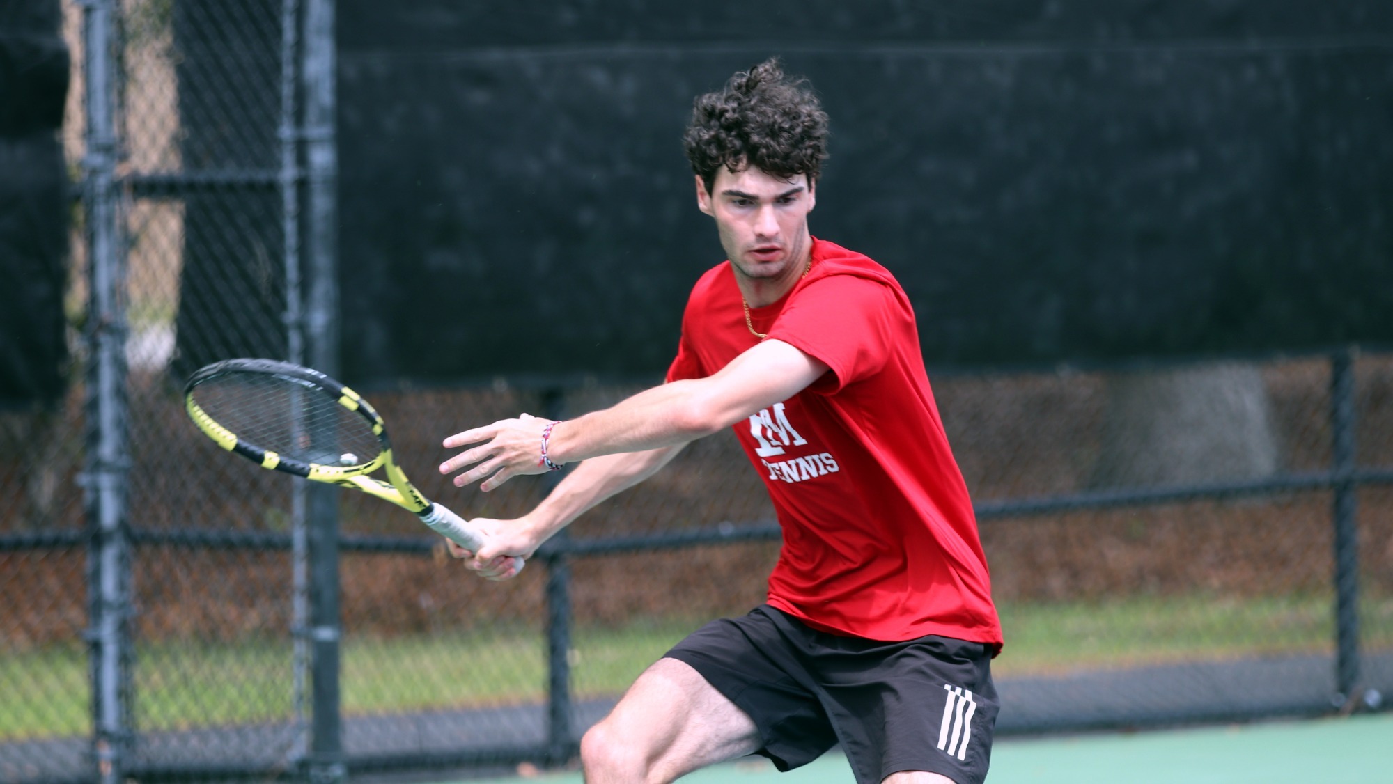 MT26 Alexandre Frigout looks to return a shot versus Barton College