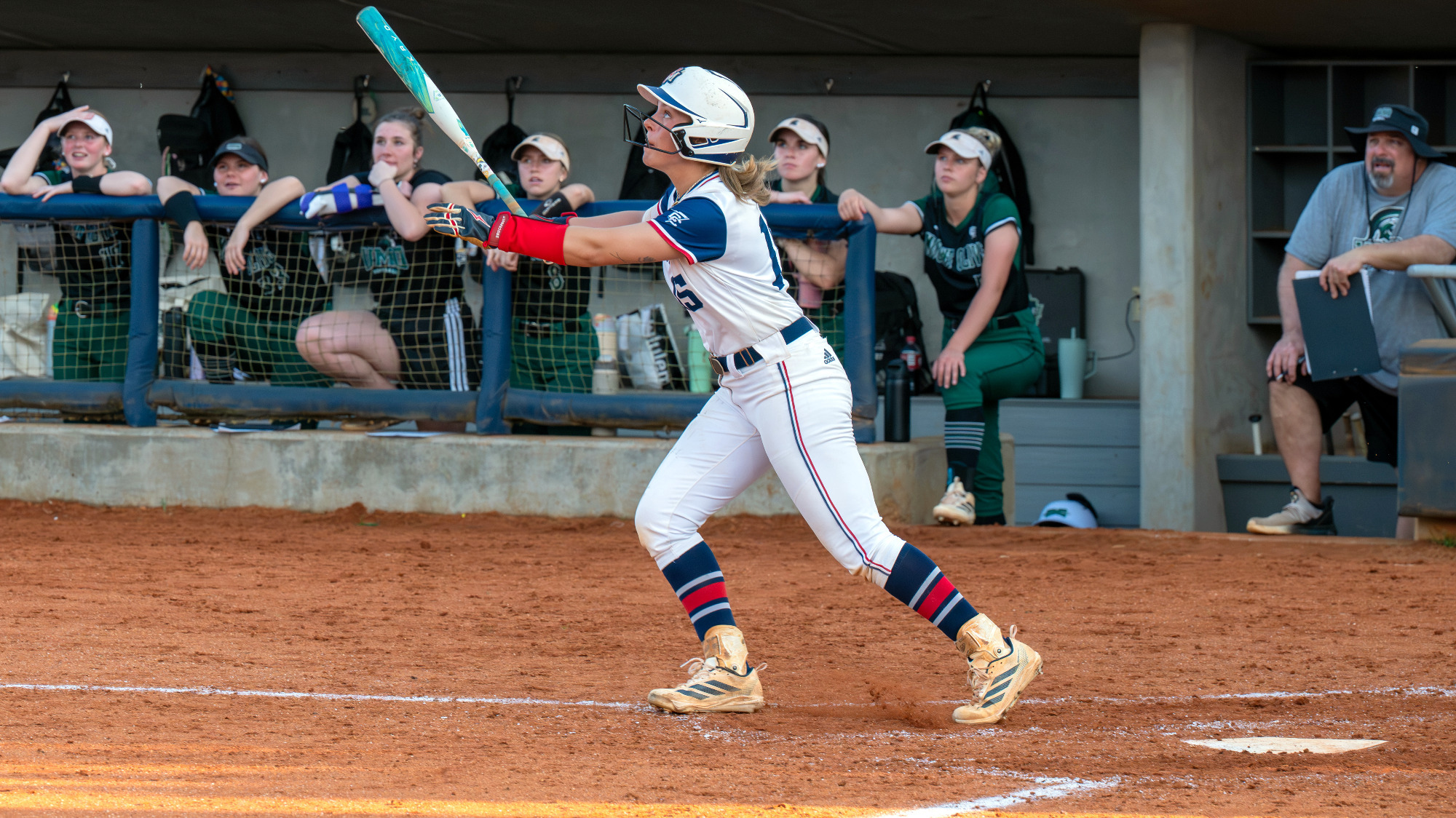 SB26 Anderson Thrower follows the flight of the ball she hit versus Mount Olive