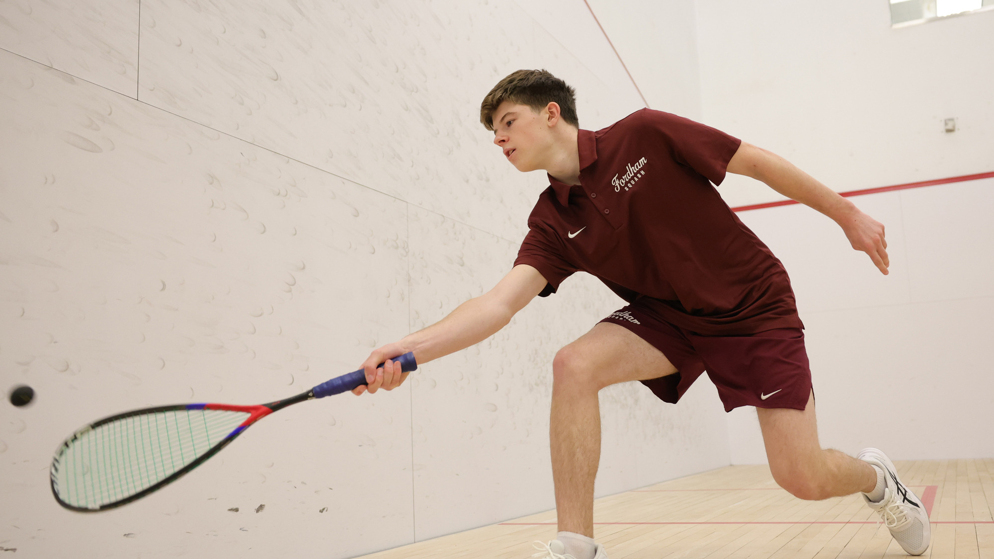 Tyler Christensen hits a forehand
