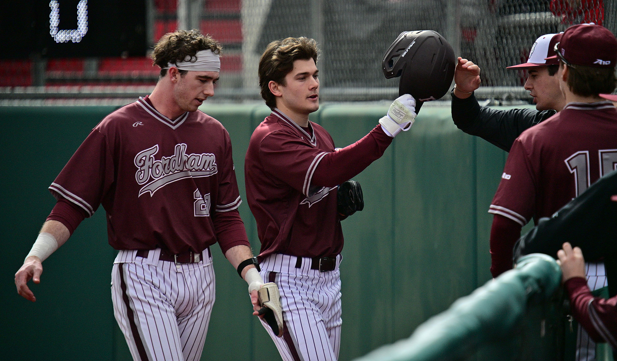 Little is greeted at the dugout after getting Fordham on the board