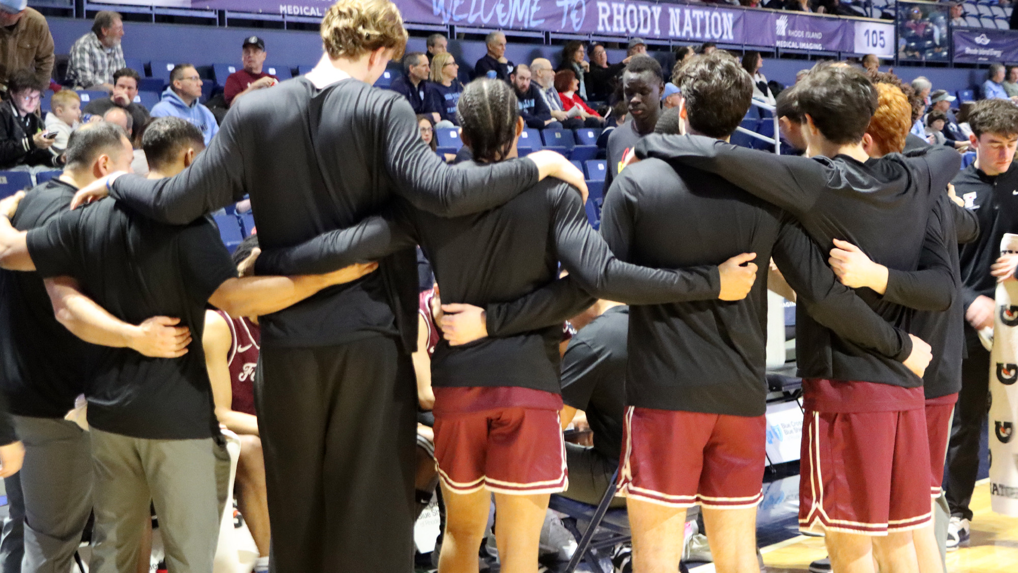 The Rams huddle prior to the game at URI